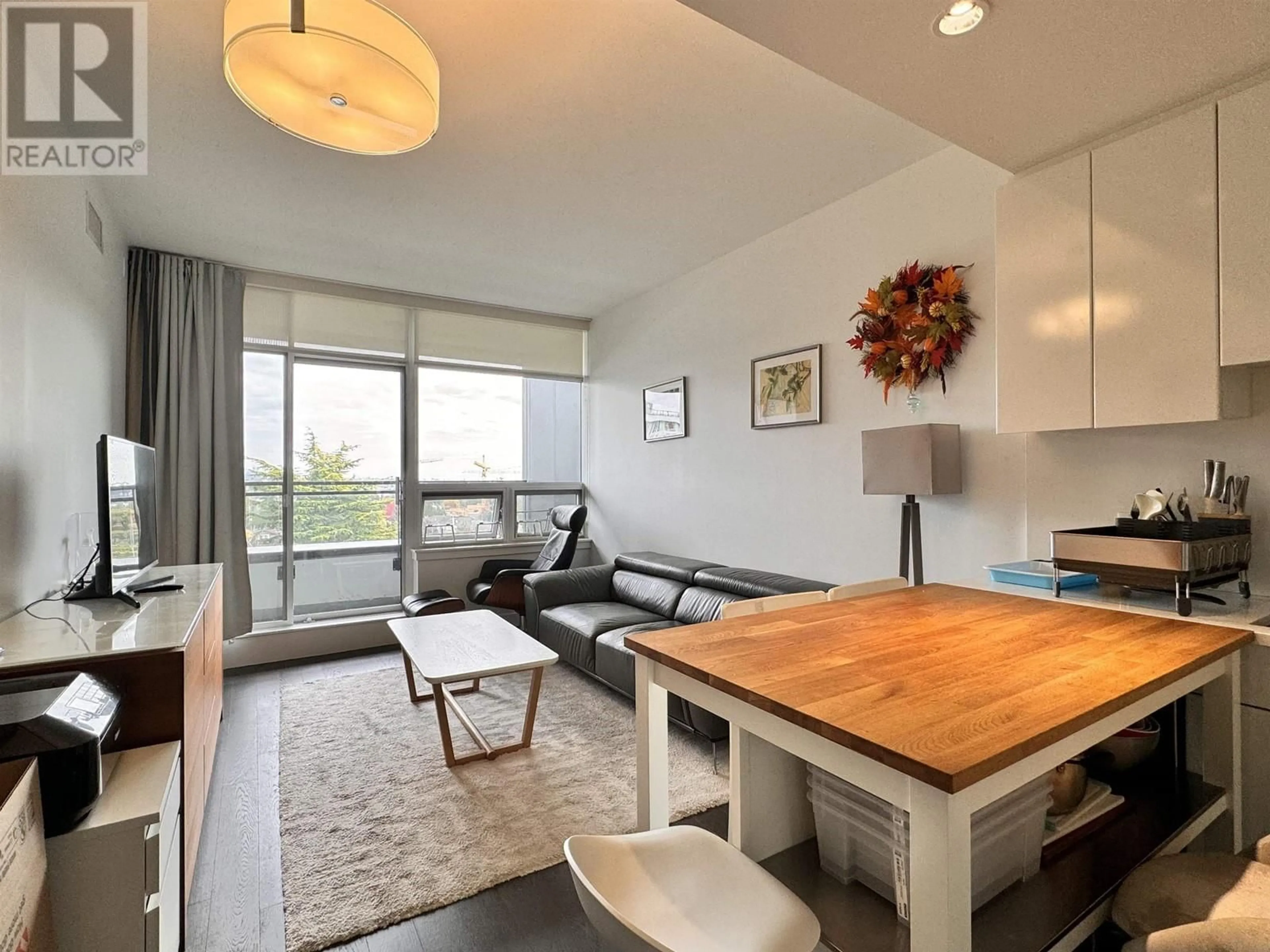 Living room with furniture, wood/laminate floor for 703 - 6383 CAMBIE STREET, Vancouver British Columbia V5Z0G7