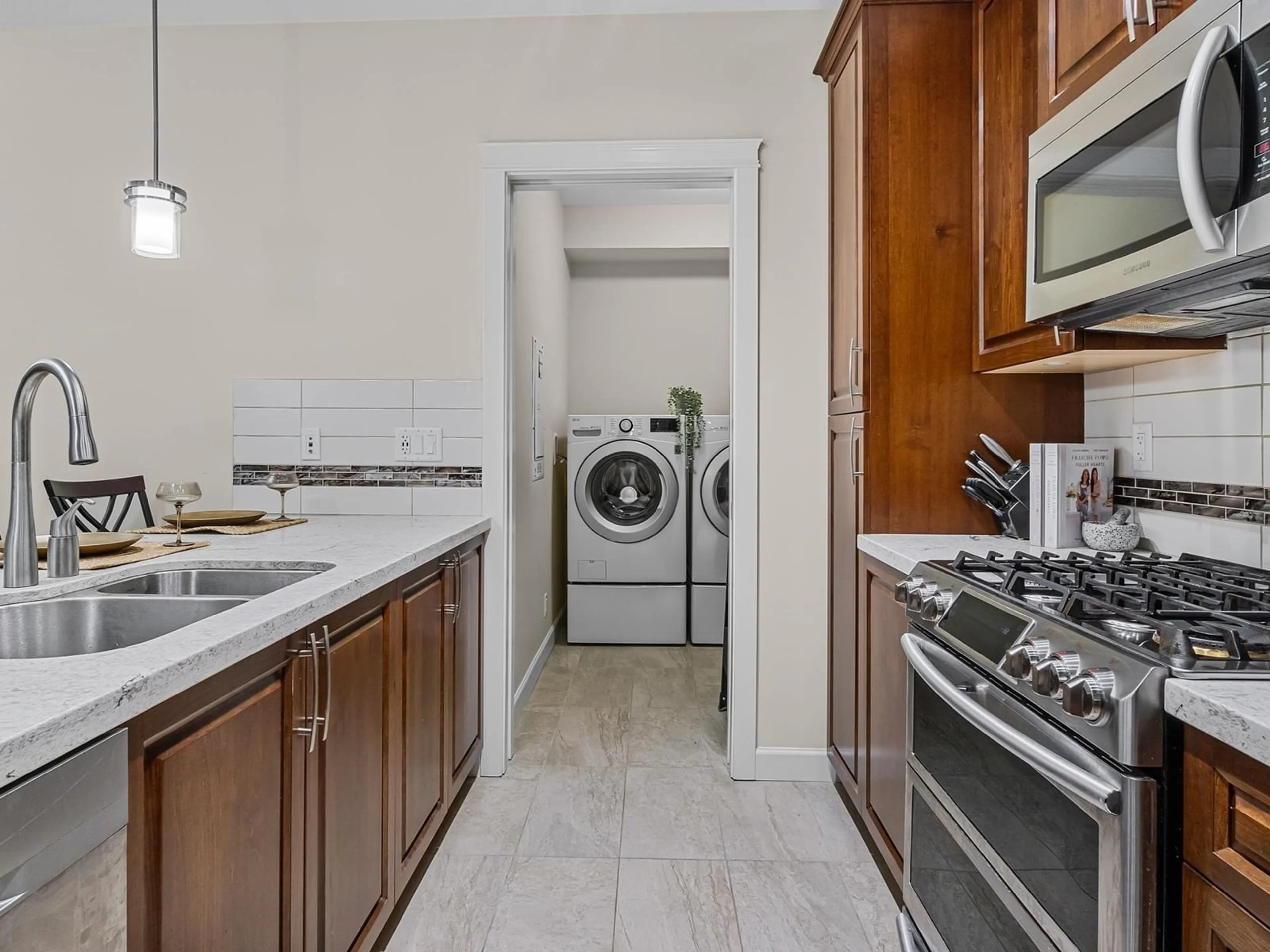 Kitchen with laundary machines, ceramic/tile floor for A113 - 20716 WILLOUGHBY TOWN CENTRE, Langley British Columbia V2Y3J7