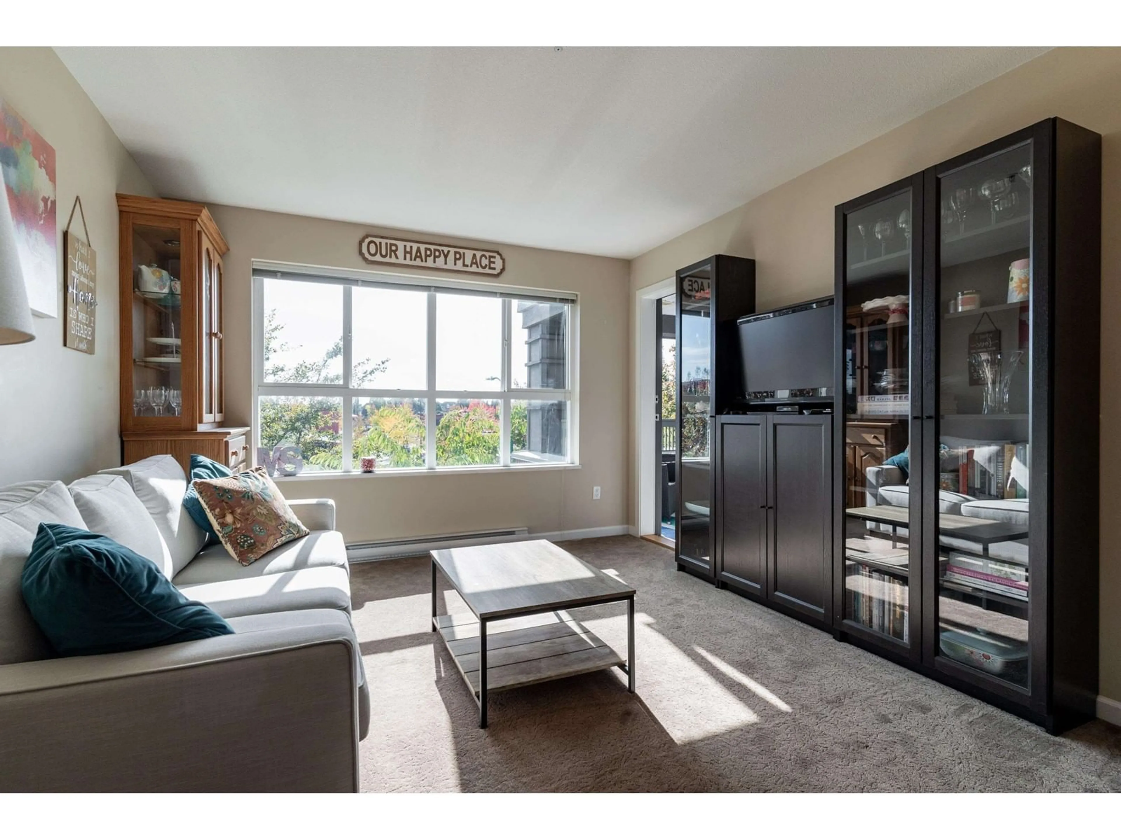 Living room with furniture, wood/laminate floor for 312 - 18755 68, Surrey British Columbia V4N0Z9