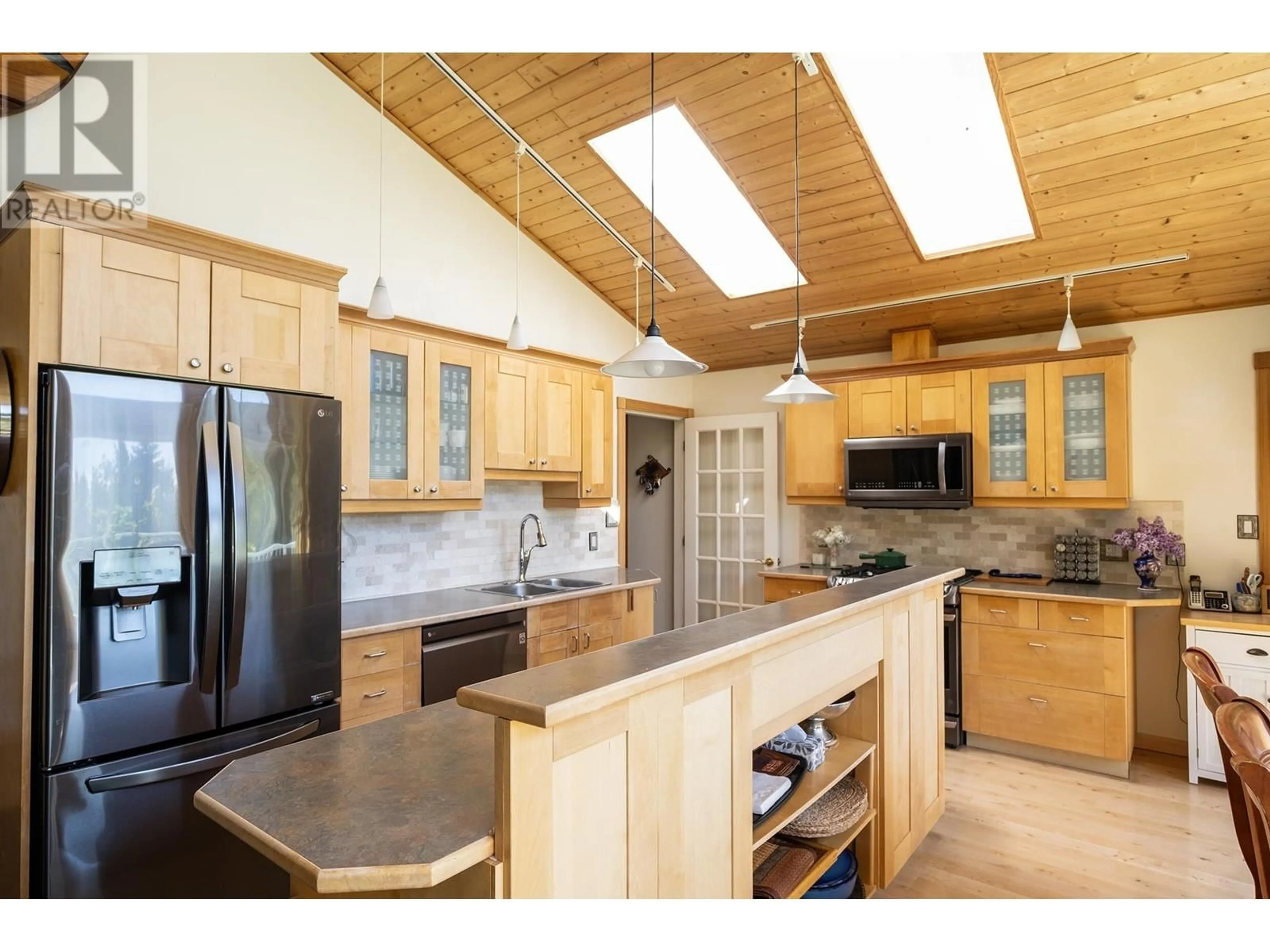 Open concept kitchen, wood/laminate floor for 2556 LOWER ROAD, Roberts Creek British Columbia V0N2W4