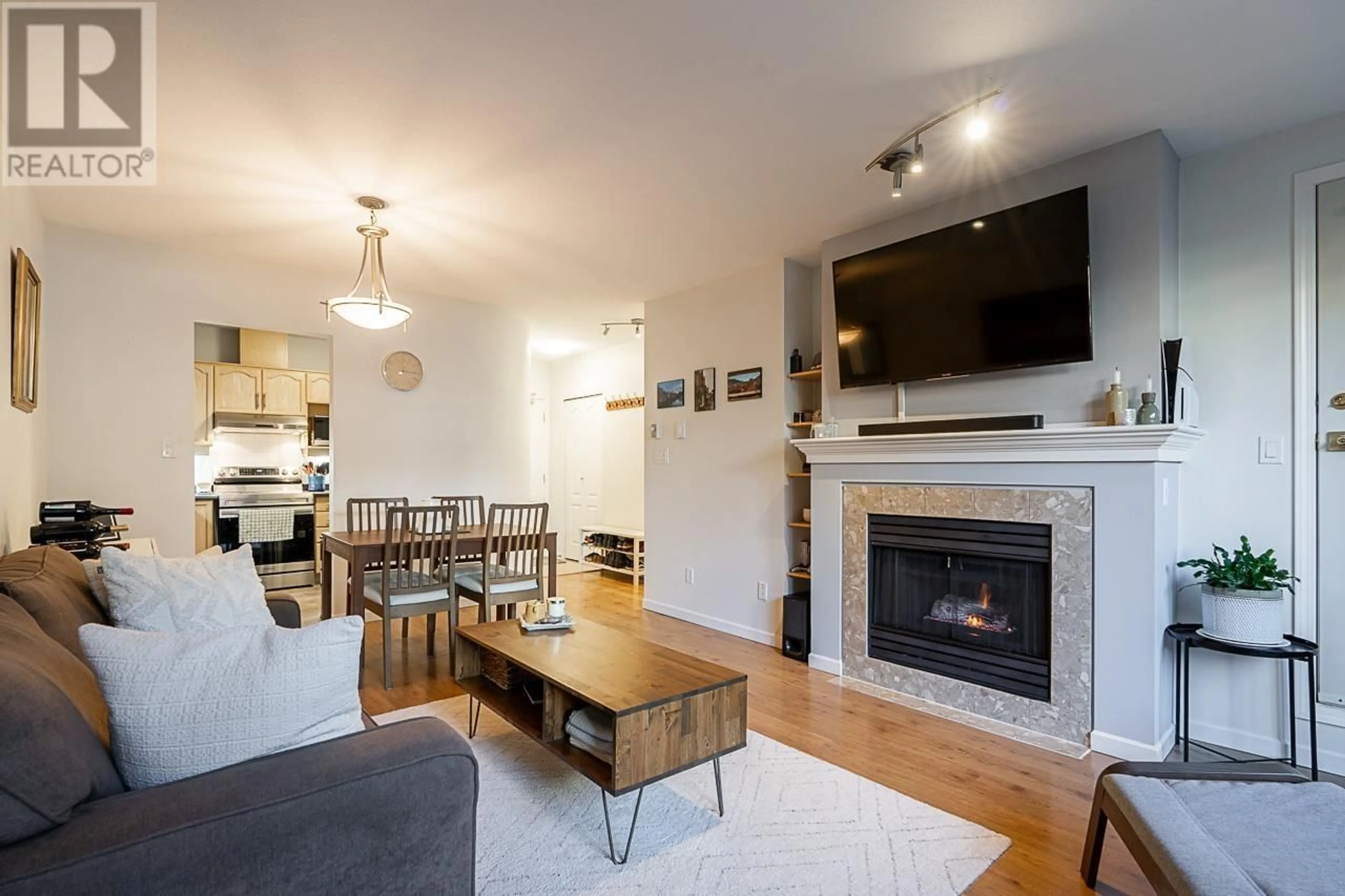 Living room with furniture, wood/laminate floor for 206 - 6742 STATION HILL COURT, Burnaby British Columbia V3N4V2