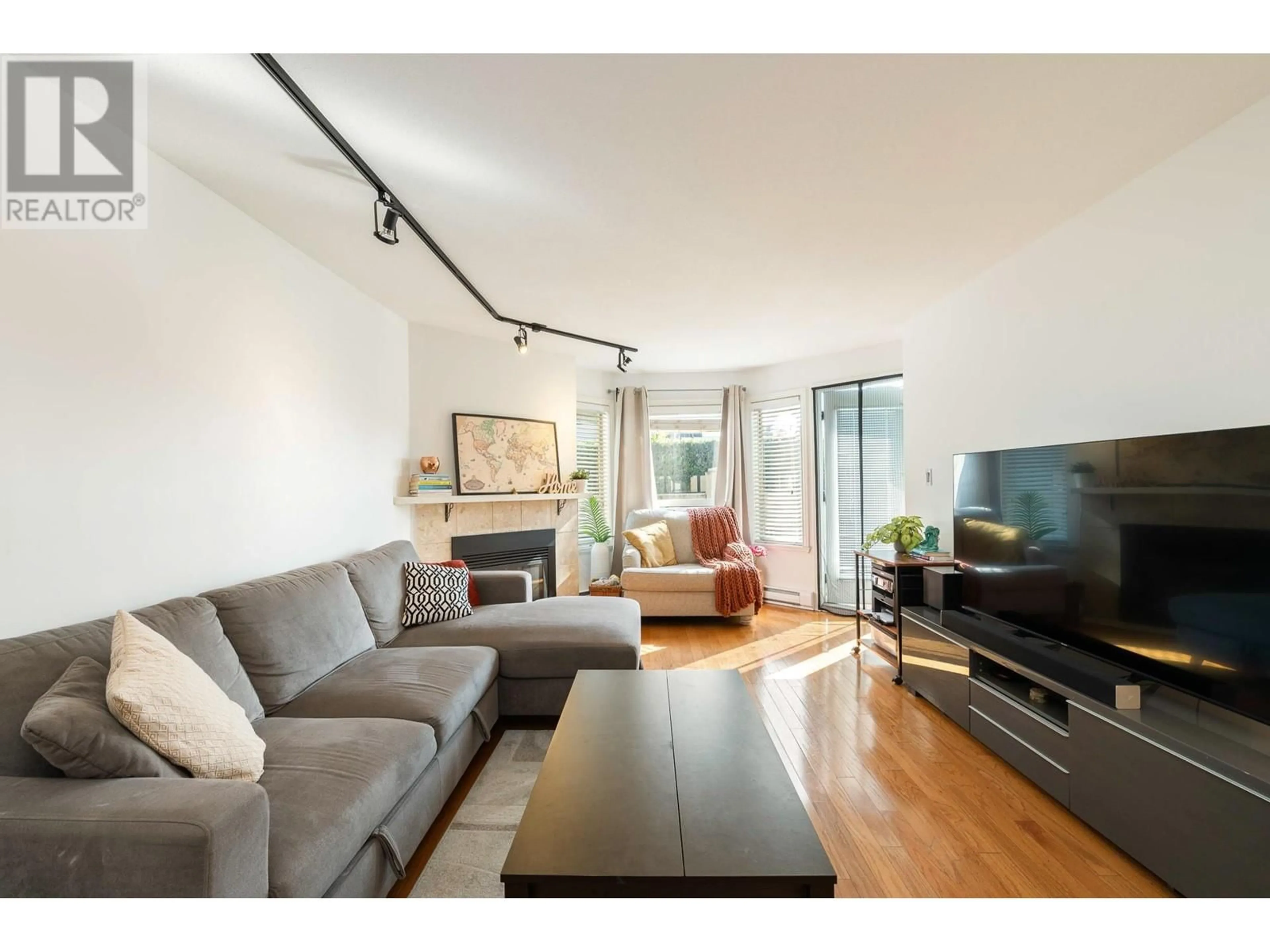 Living room with furniture, wood/laminate floor for 105 - 175 4TH STREET, North Vancouver British Columbia V7M1H6