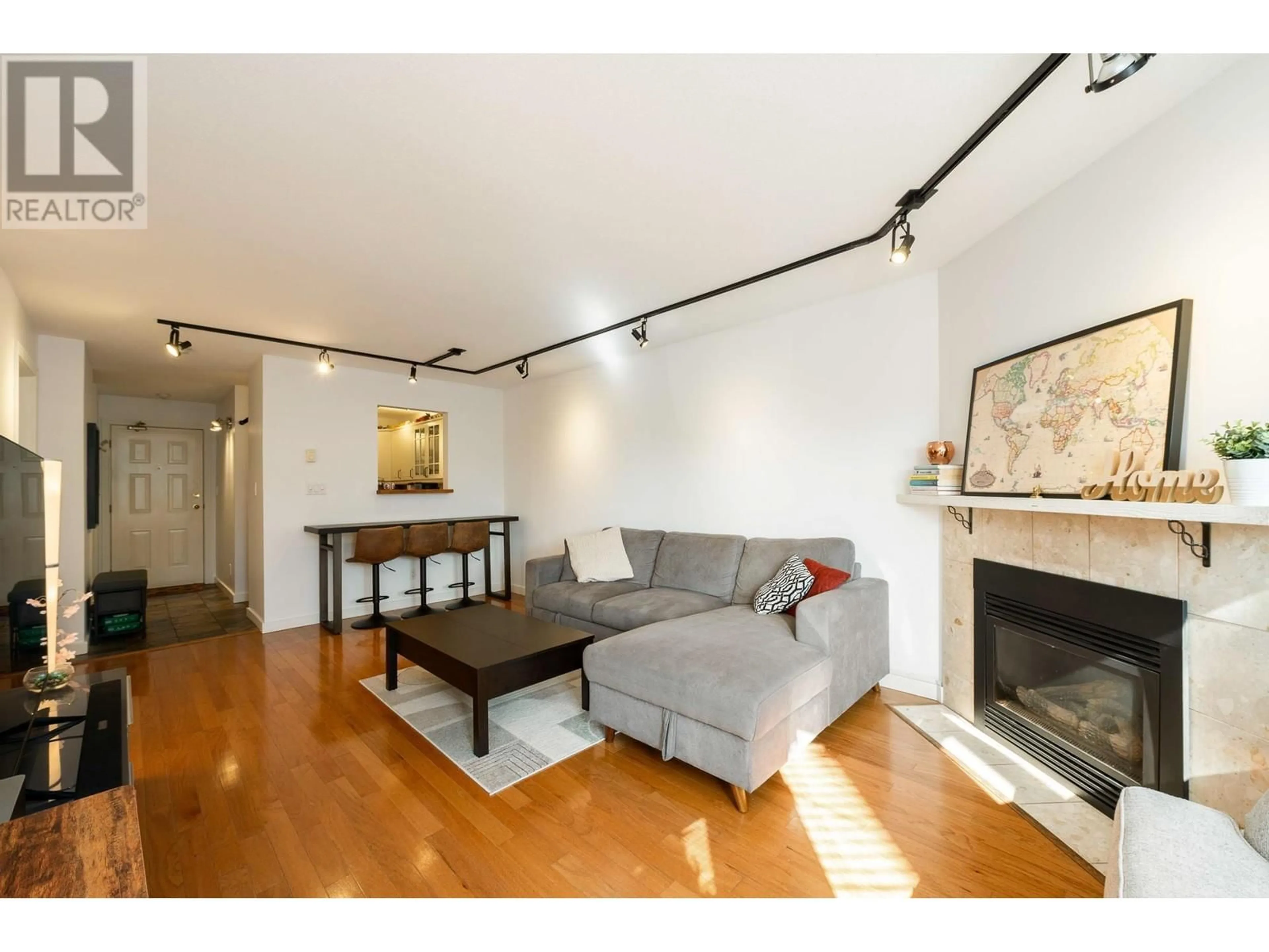 Living room with furniture, wood/laminate floor for 105 - 175 4TH STREET, North Vancouver British Columbia V7M1H6
