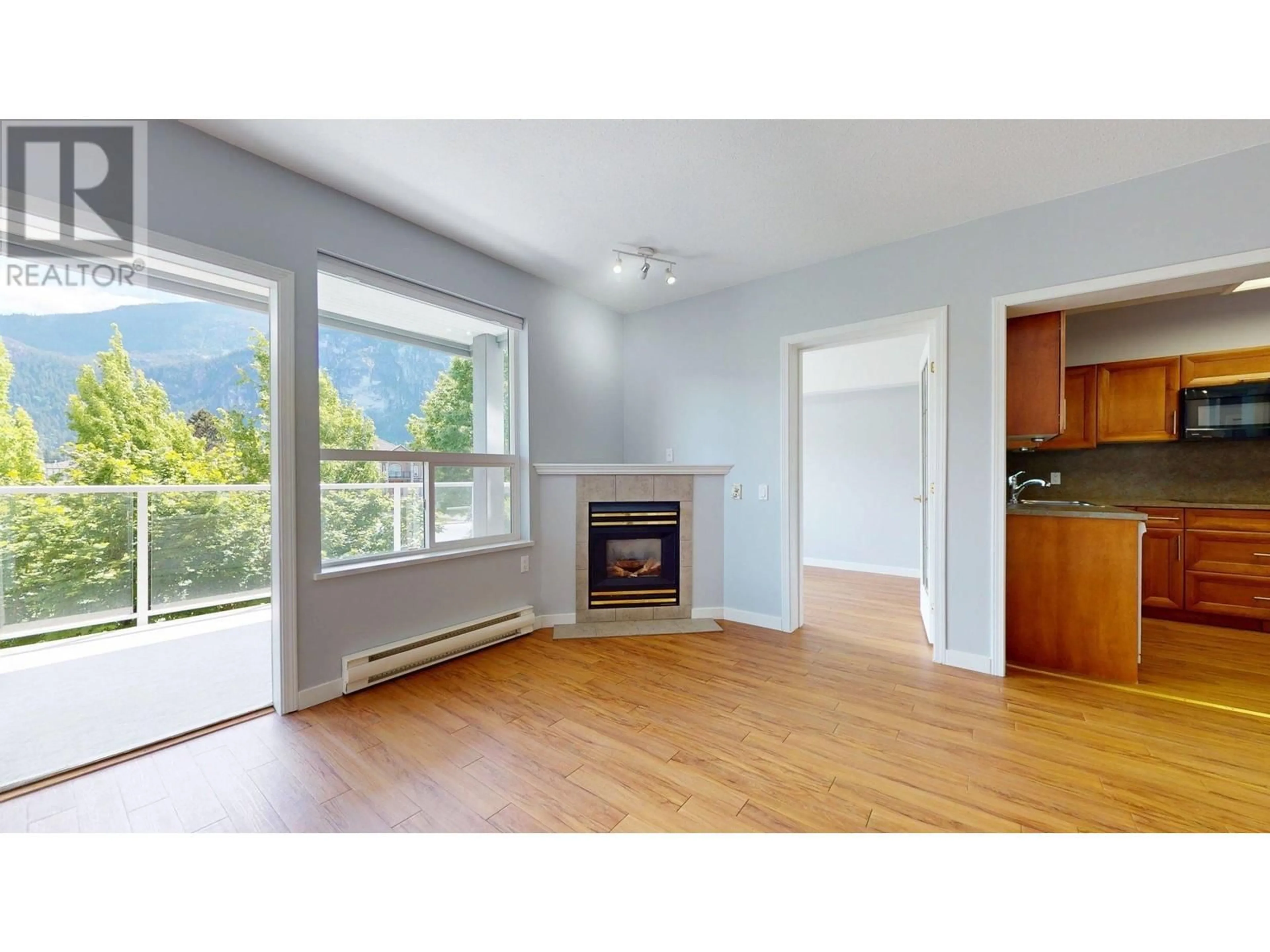 Living room with furniture, wood/laminate floor for 201 - 1203 PEMBERTON AVENUE, Squamish British Columbia V0N3G0