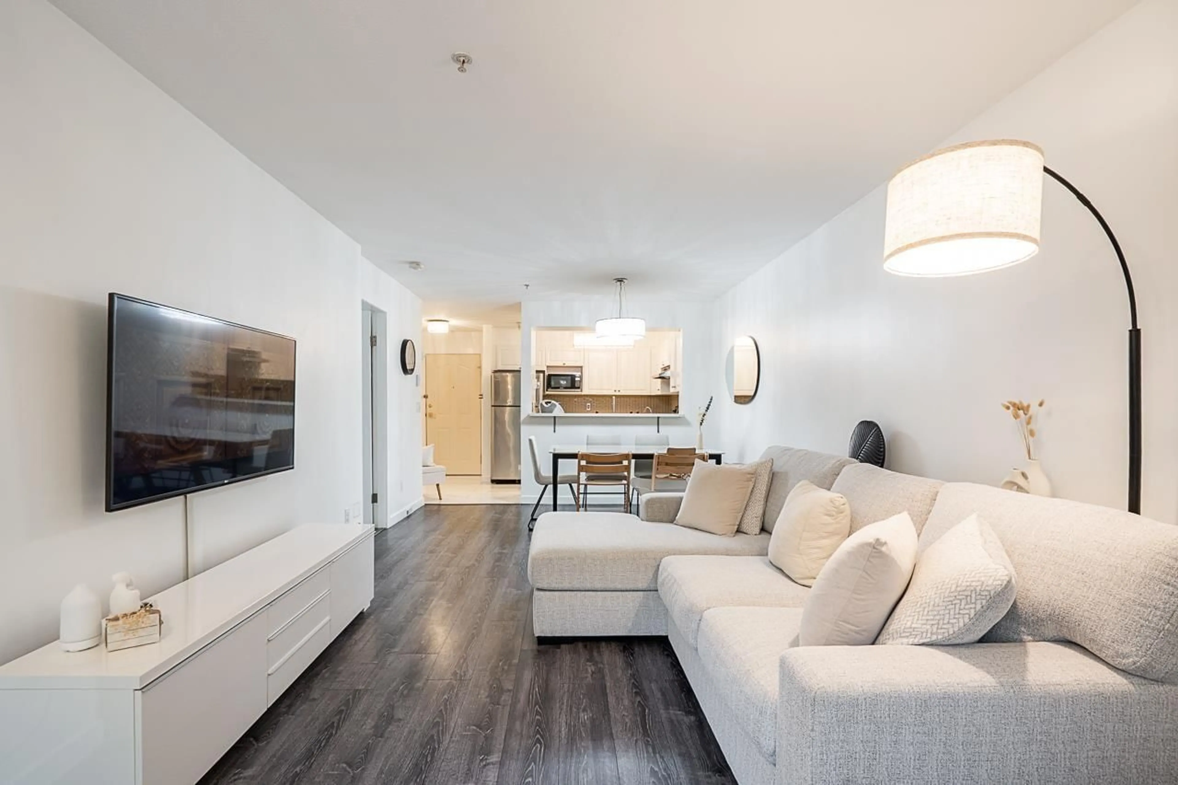Living room with furniture, wood/laminate floor for 110 - 8110 120A, Surrey British Columbia V3W3P3