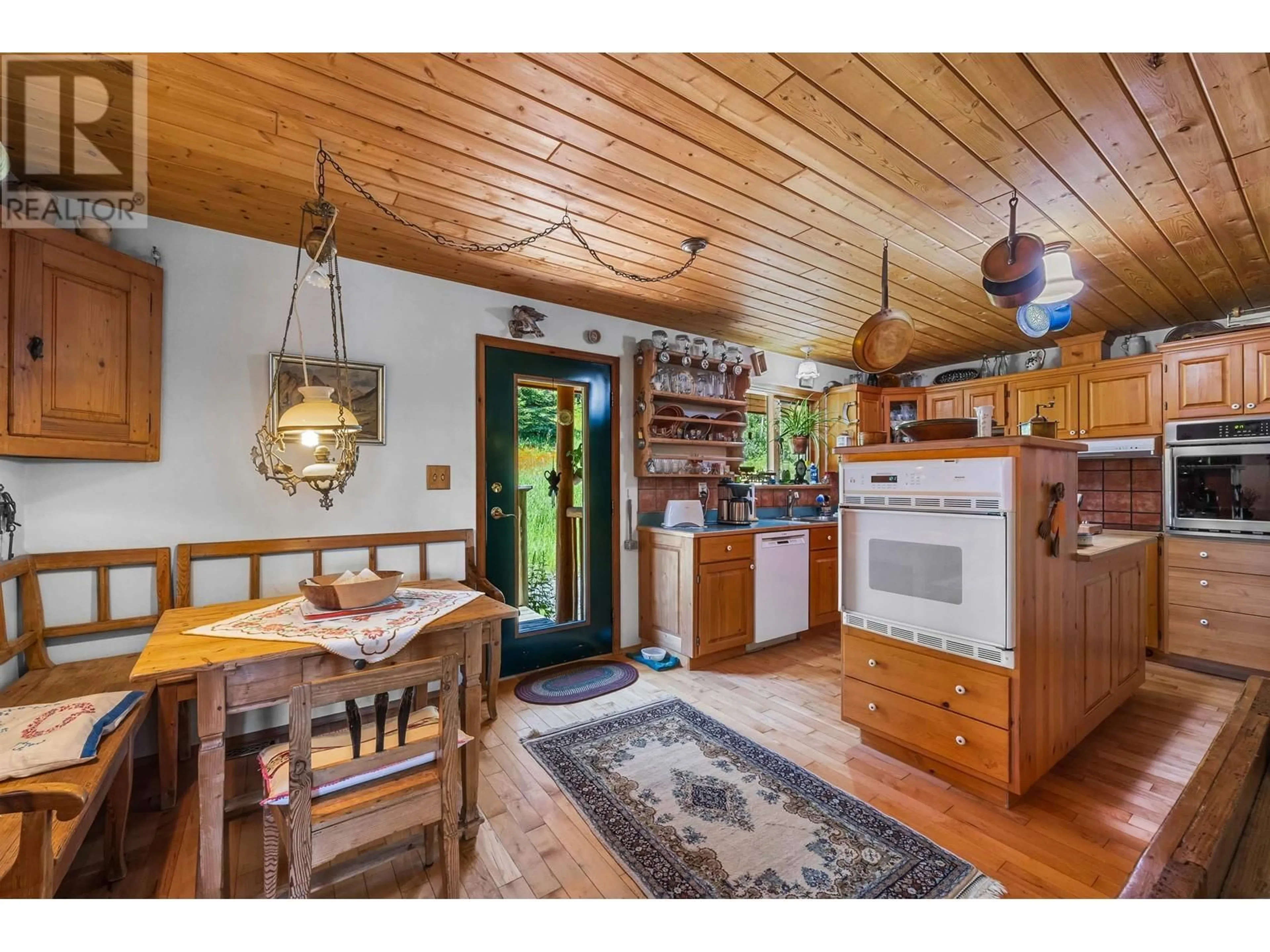 Rustic kitchen, wood/laminate floor for 7649 JULSRUD ROAD, Deka Lake / Sulphurous / Hathaway Lakes British Columbia V0K1X3