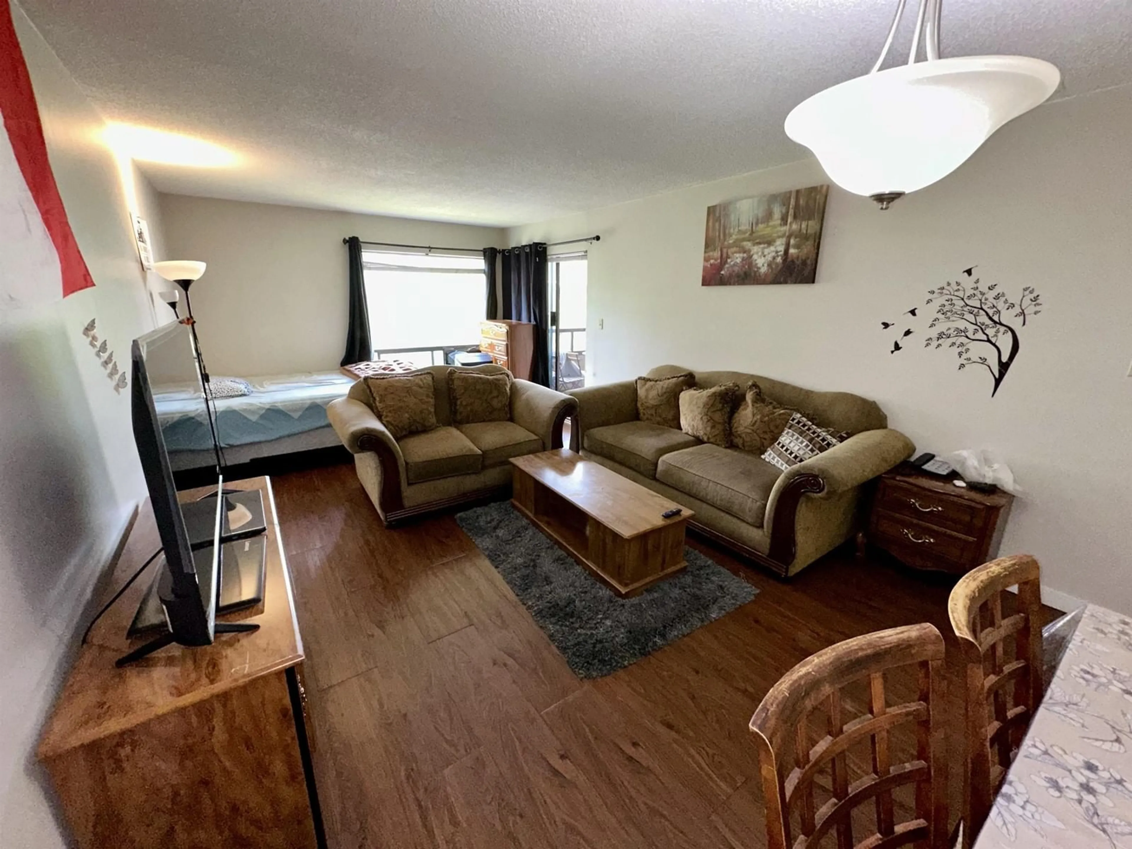 Living room with furniture, wood/laminate floor for 311 - 13344 102A, Surrey British Columbia V3T5J7