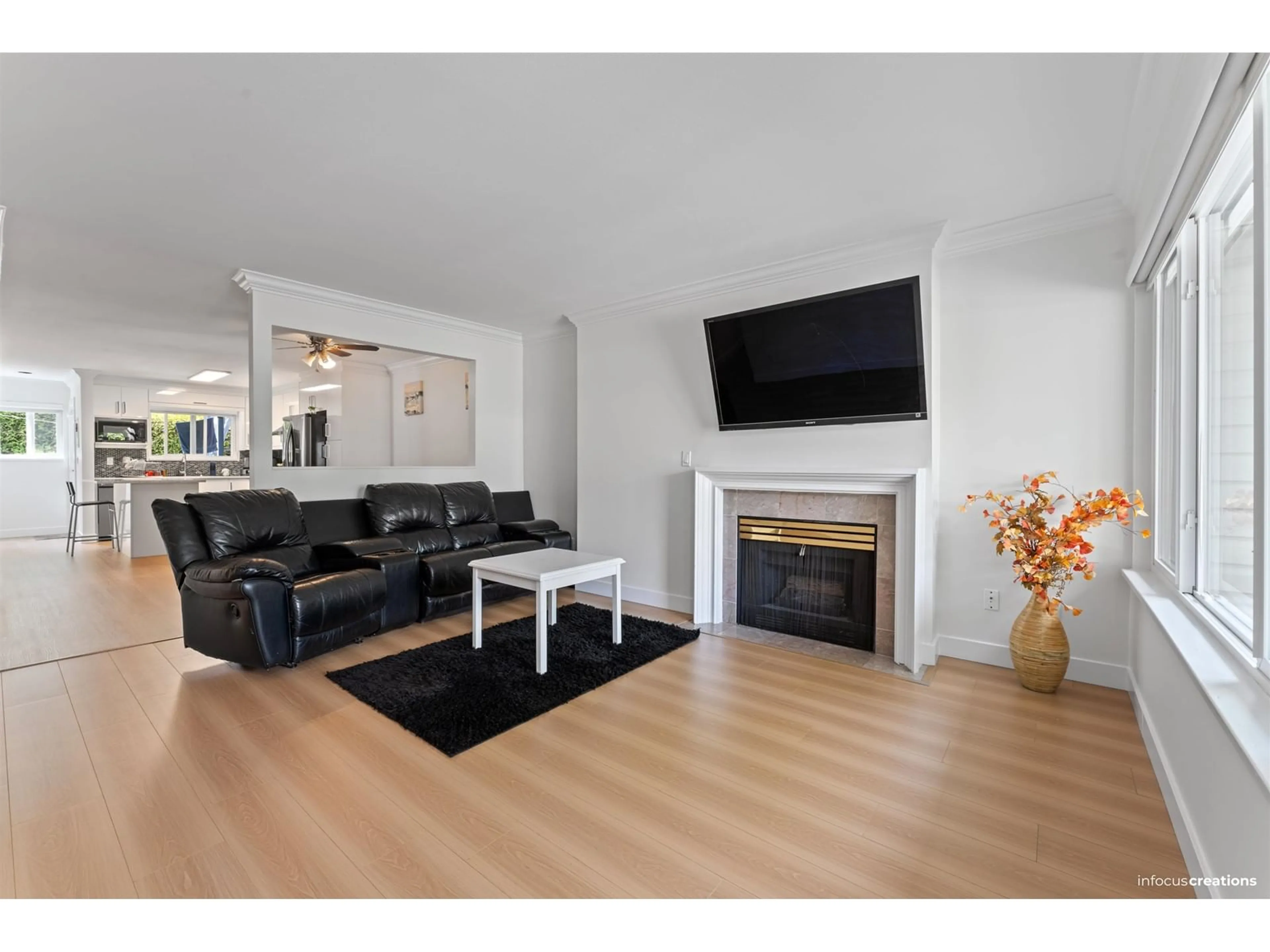 Living room with furniture, wood/laminate floor for 101 - 7881 120A, Surrey British Columbia V3W0Y7
