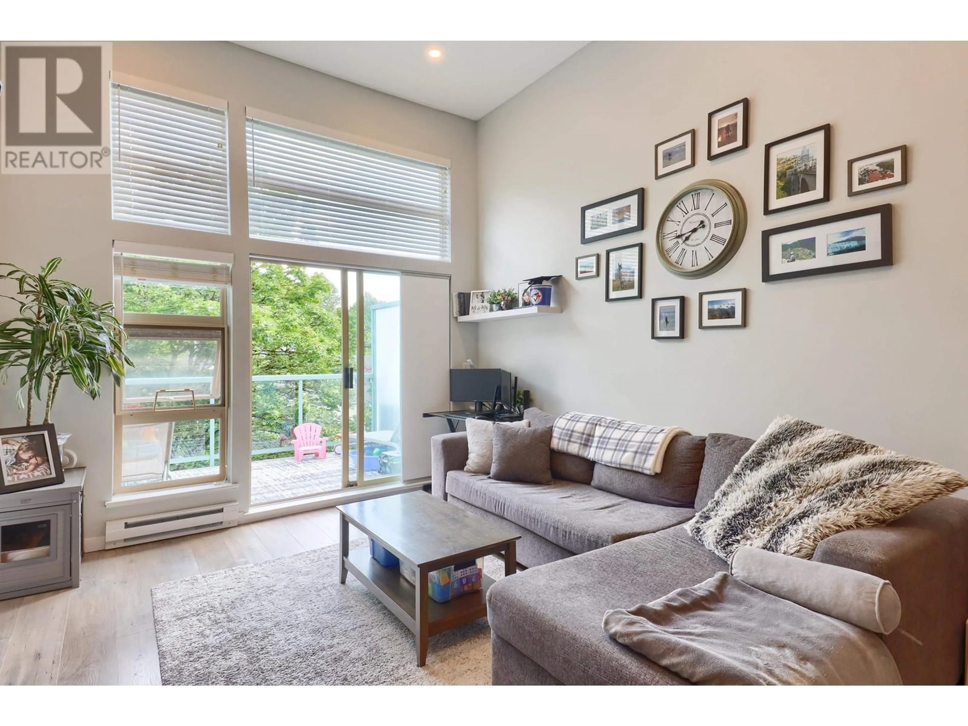 Living room with furniture, wood/laminate floor for 605 - 301 MAUDE ROAD, Port Moody British Columbia V3H5B1