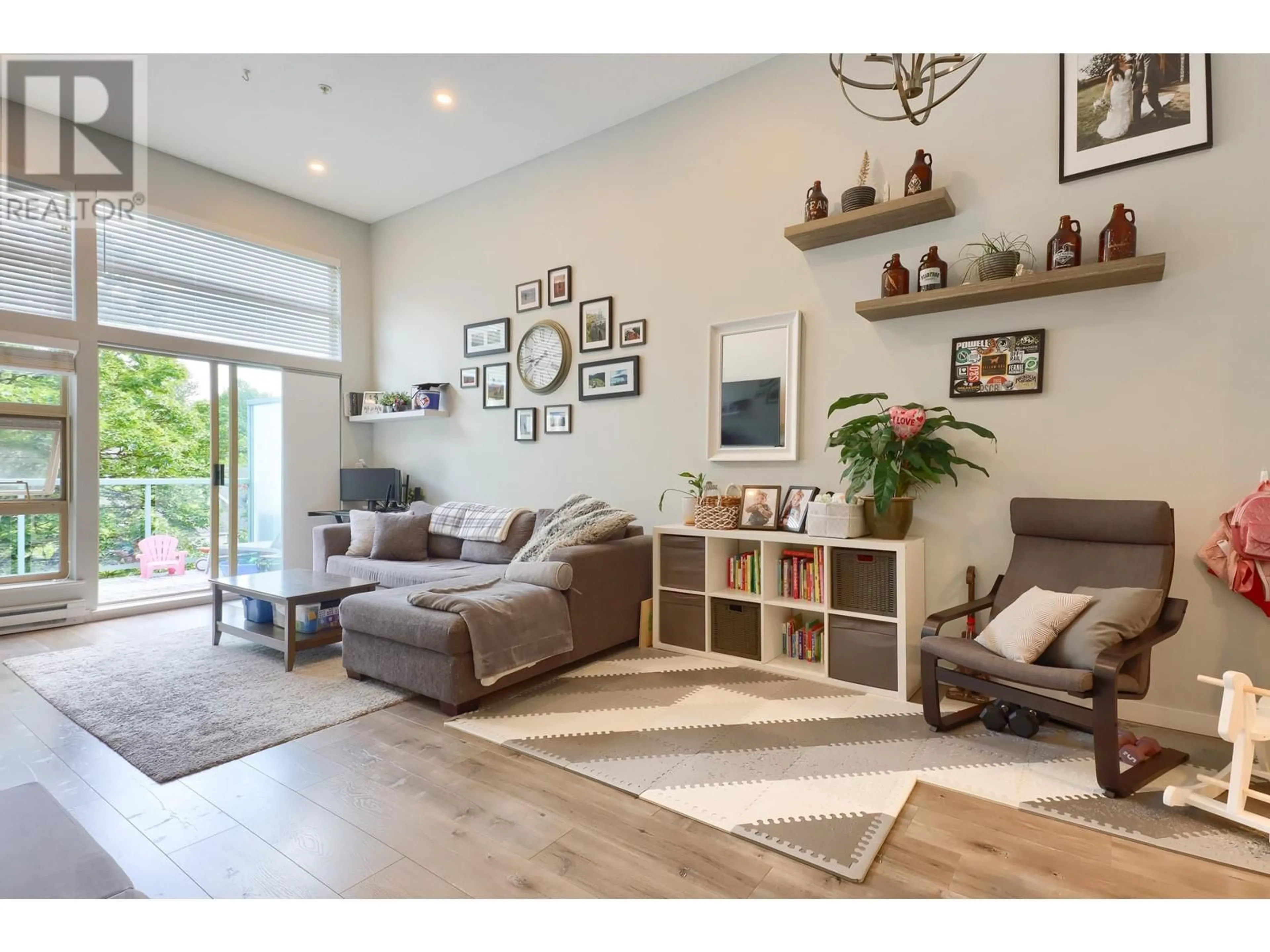 Living room with furniture, wood/laminate floor for 605 - 301 MAUDE ROAD, Port Moody British Columbia V3H5B1