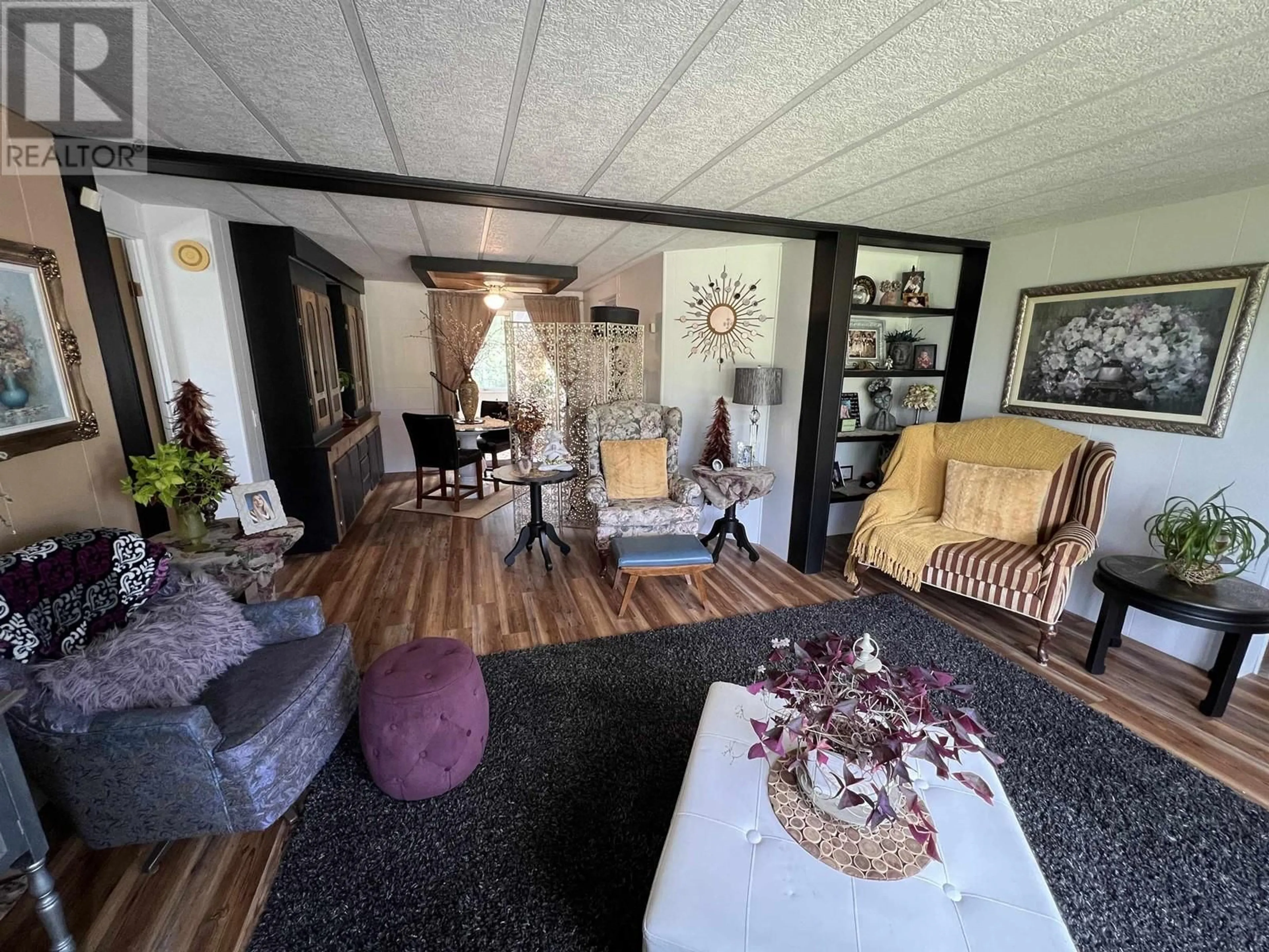 Living room with furniture, wood/laminate floor for 6912 OLD ALASKA HIGHWAY, Fort Nelson British Columbia V0C1R0