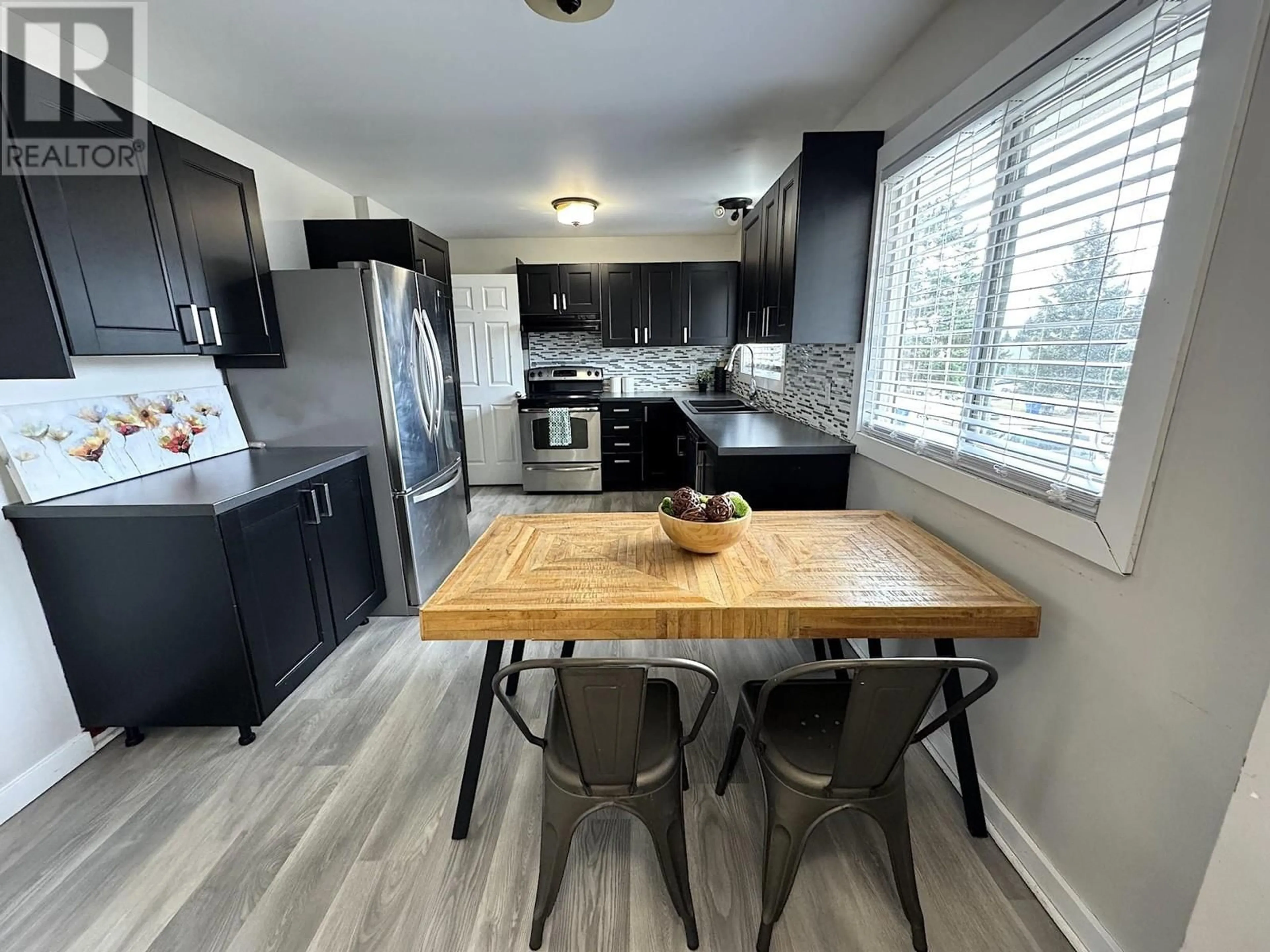 Open concept kitchen, wood/laminate floor for 8815 88 STREET, Fort St. John British Columbia V1J5A3
