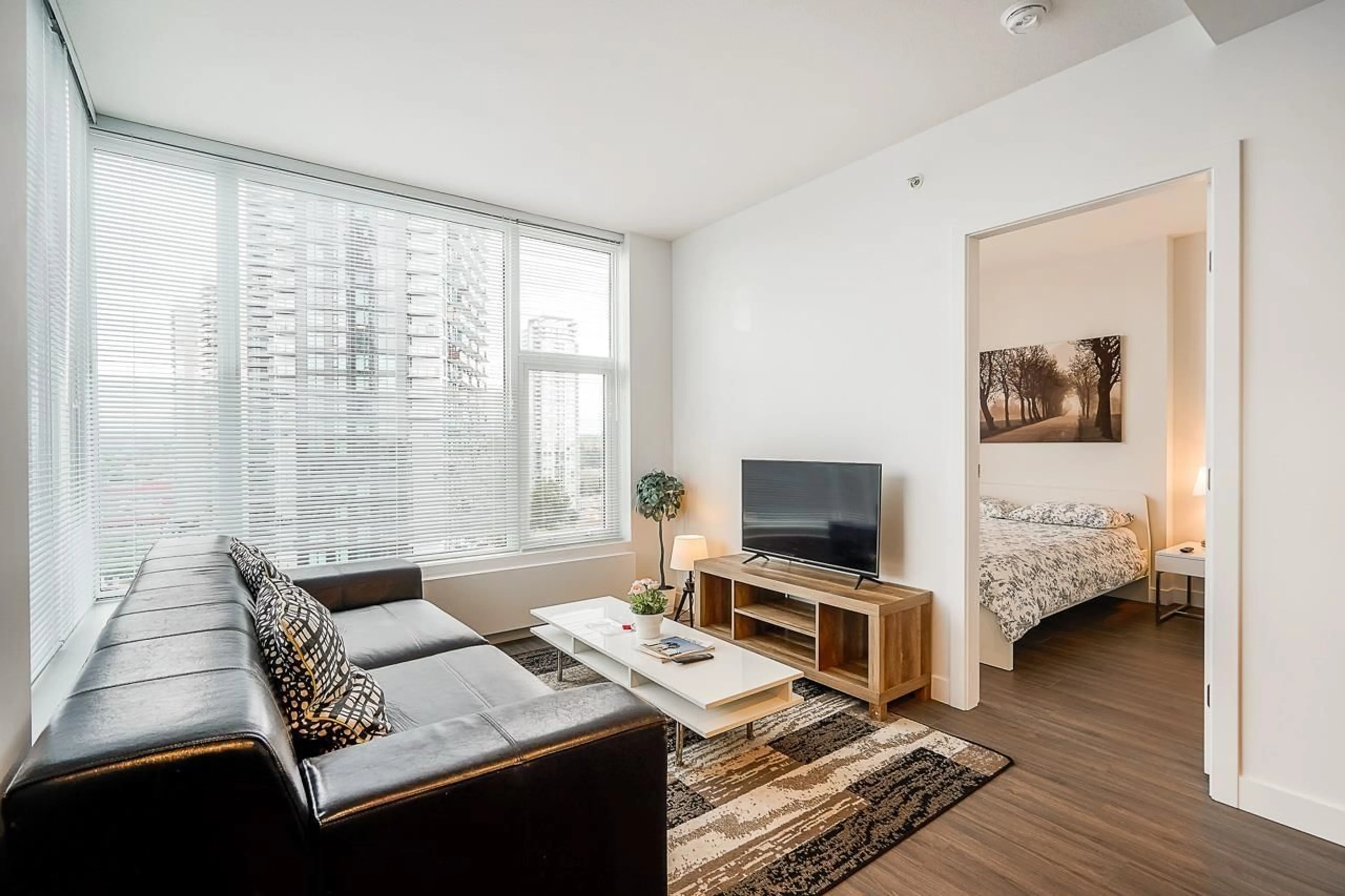 Living room with furniture, wood/laminate floor for 1404 - 13655 FRASER, Surrey British Columbia V3T0P8