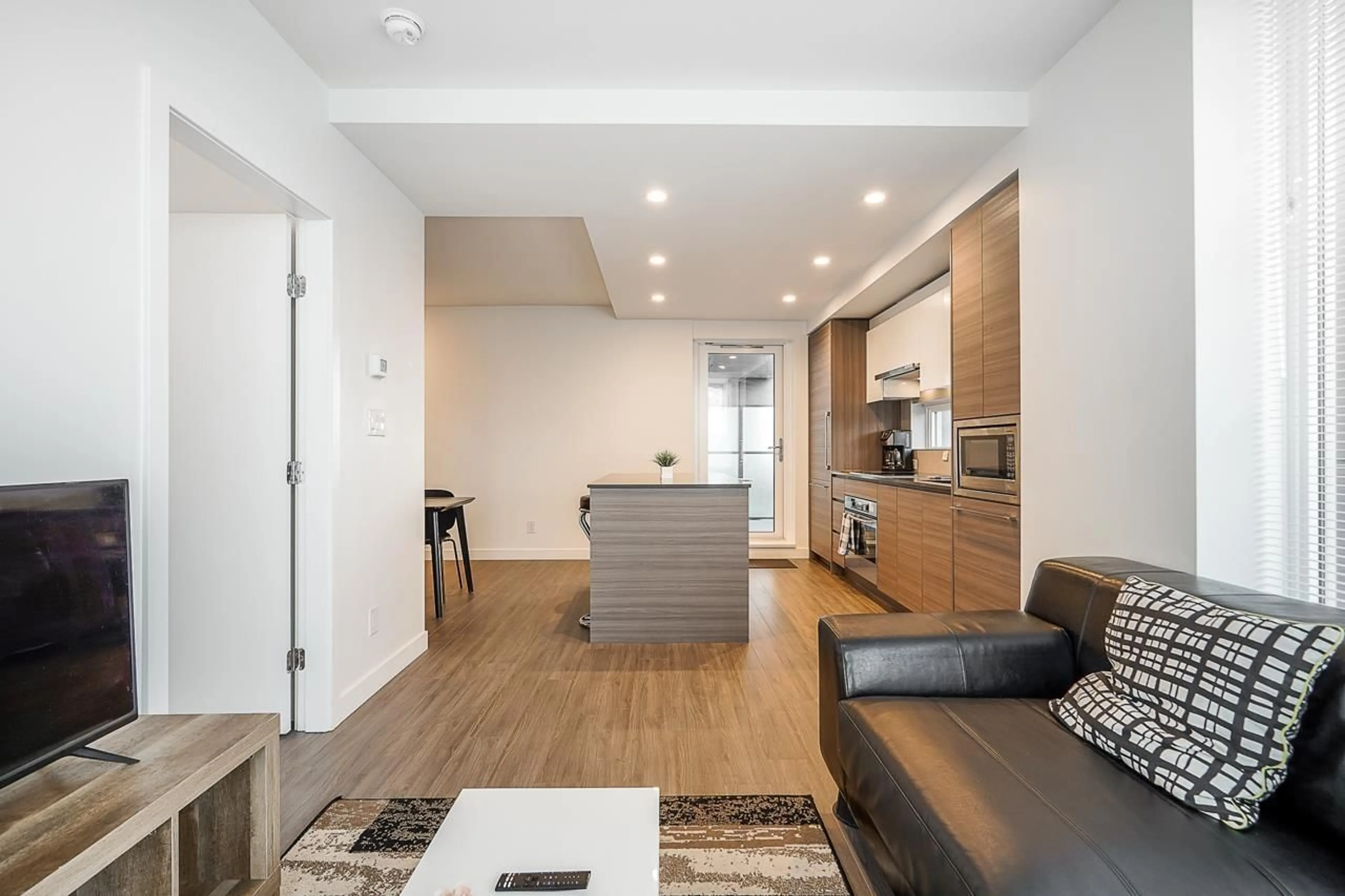 Open concept kitchen, wood/laminate floor for 1404 - 13655 FRASER, Surrey British Columbia V3T0P8