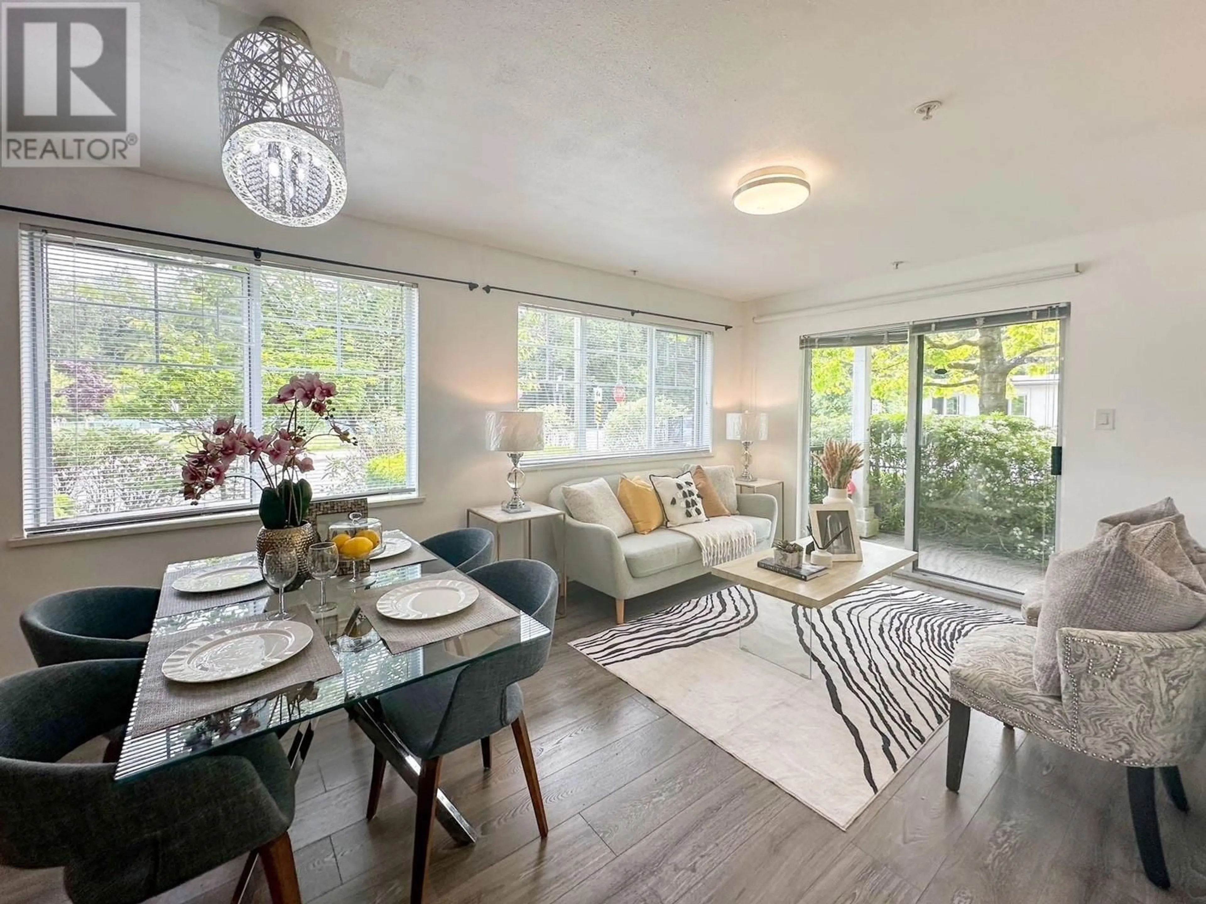 Living room with furniture, wood/laminate floor for 108 - 2780 ACADIA ROAD, Vancouver British Columbia V6T2L3