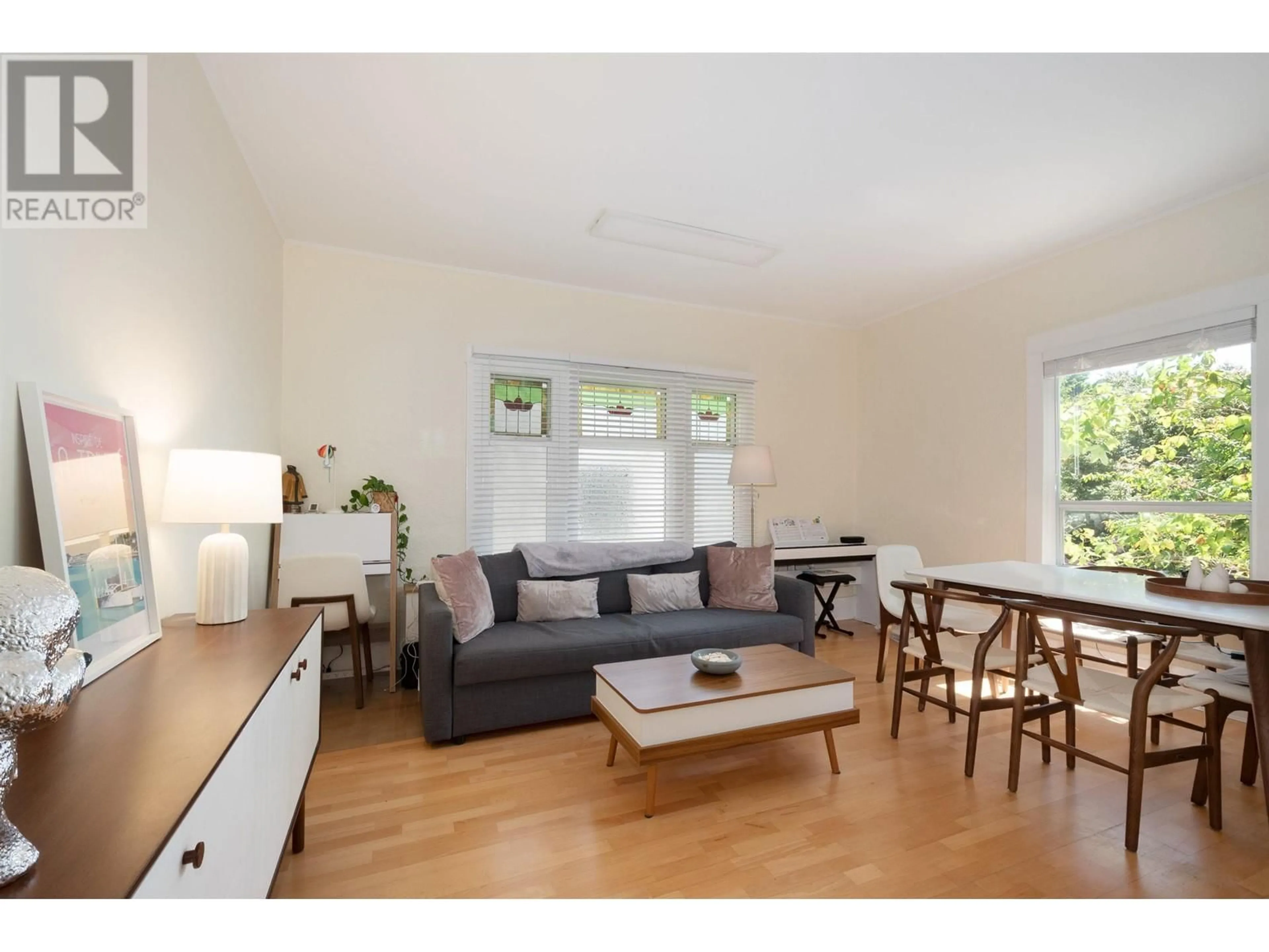 Living room with furniture, wood/laminate floor for 3652 POINT GREY ROAD, Vancouver British Columbia V6R1A9