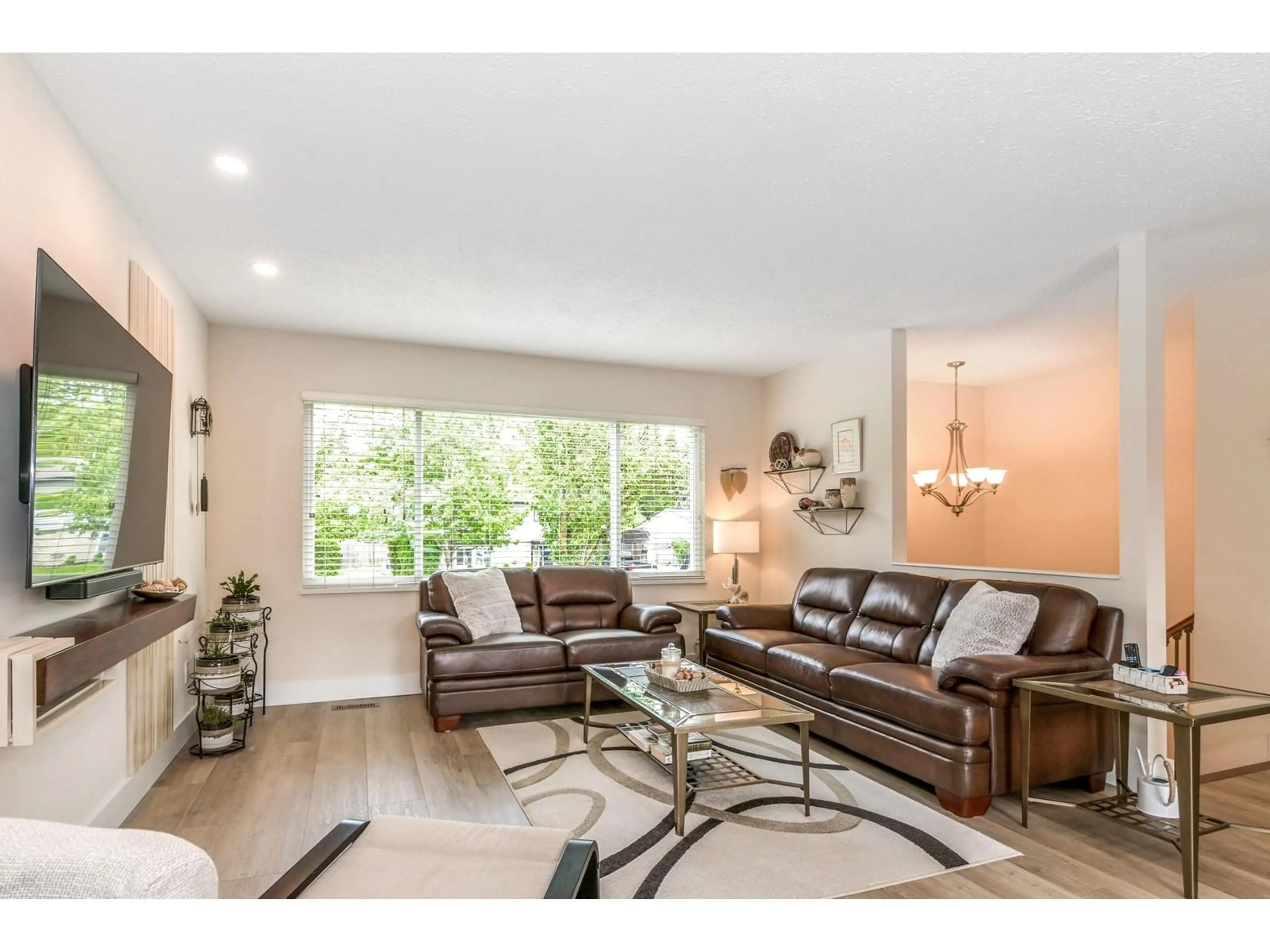 Living room with furniture, wood/laminate floor for 19360 62A, Surrey British Columbia V3S7L6
