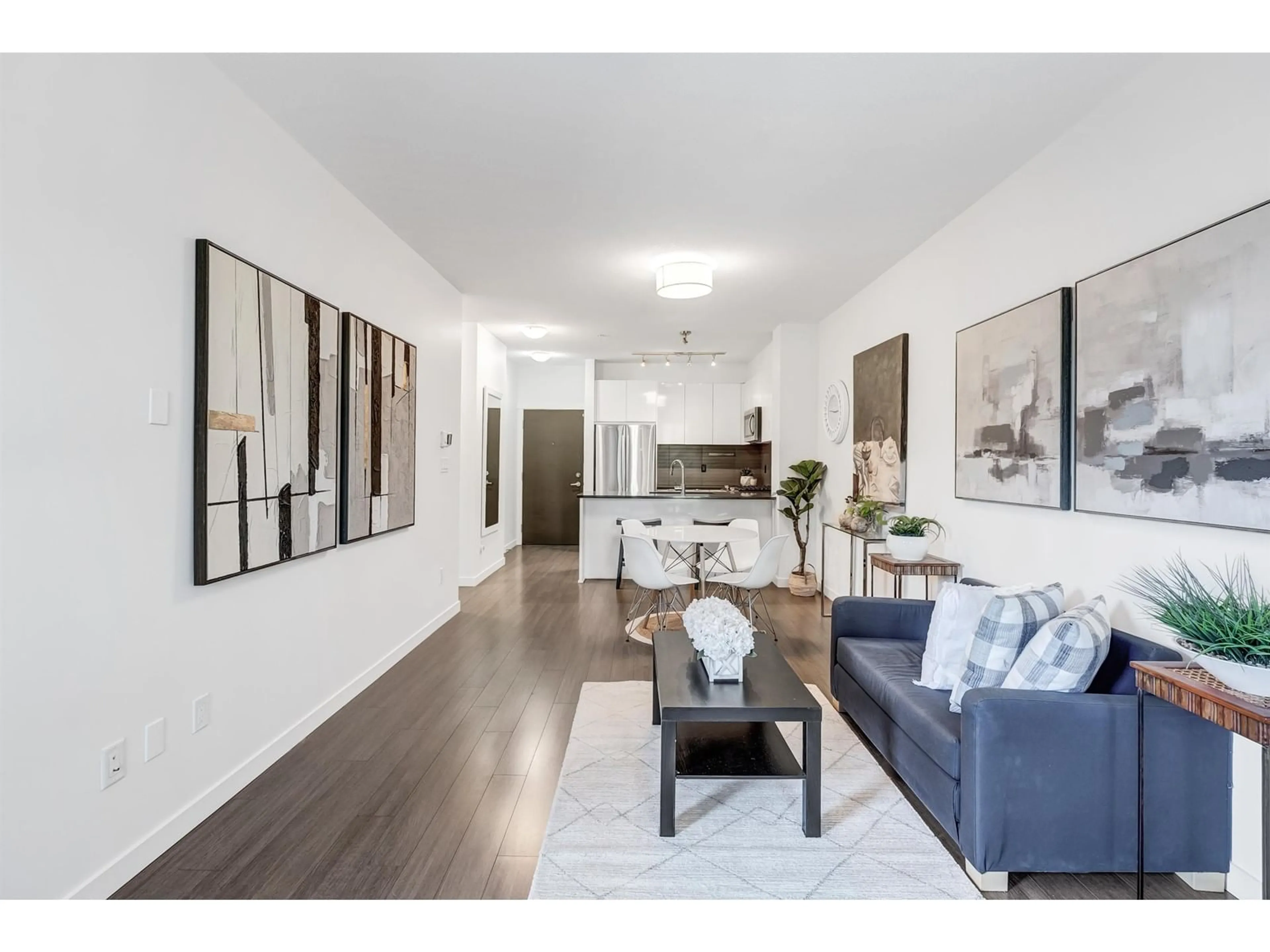 Living room with furniture, wood/laminate floor for 118 - 15138 34, Surrey British Columbia V3Z0N7