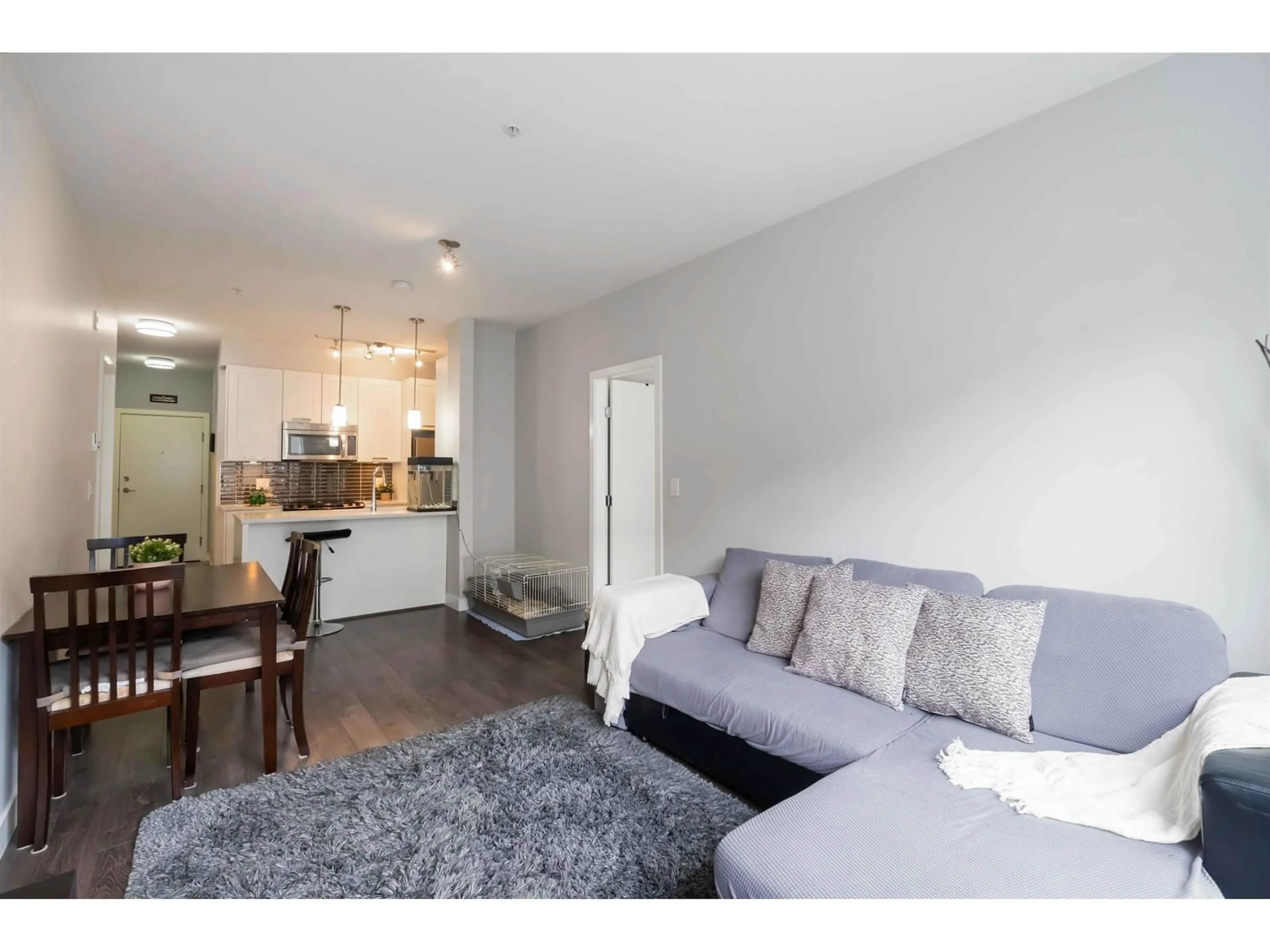 Living room with furniture, wood/laminate floor for 208 - 10455 154, Surrey British Columbia V3R0C5