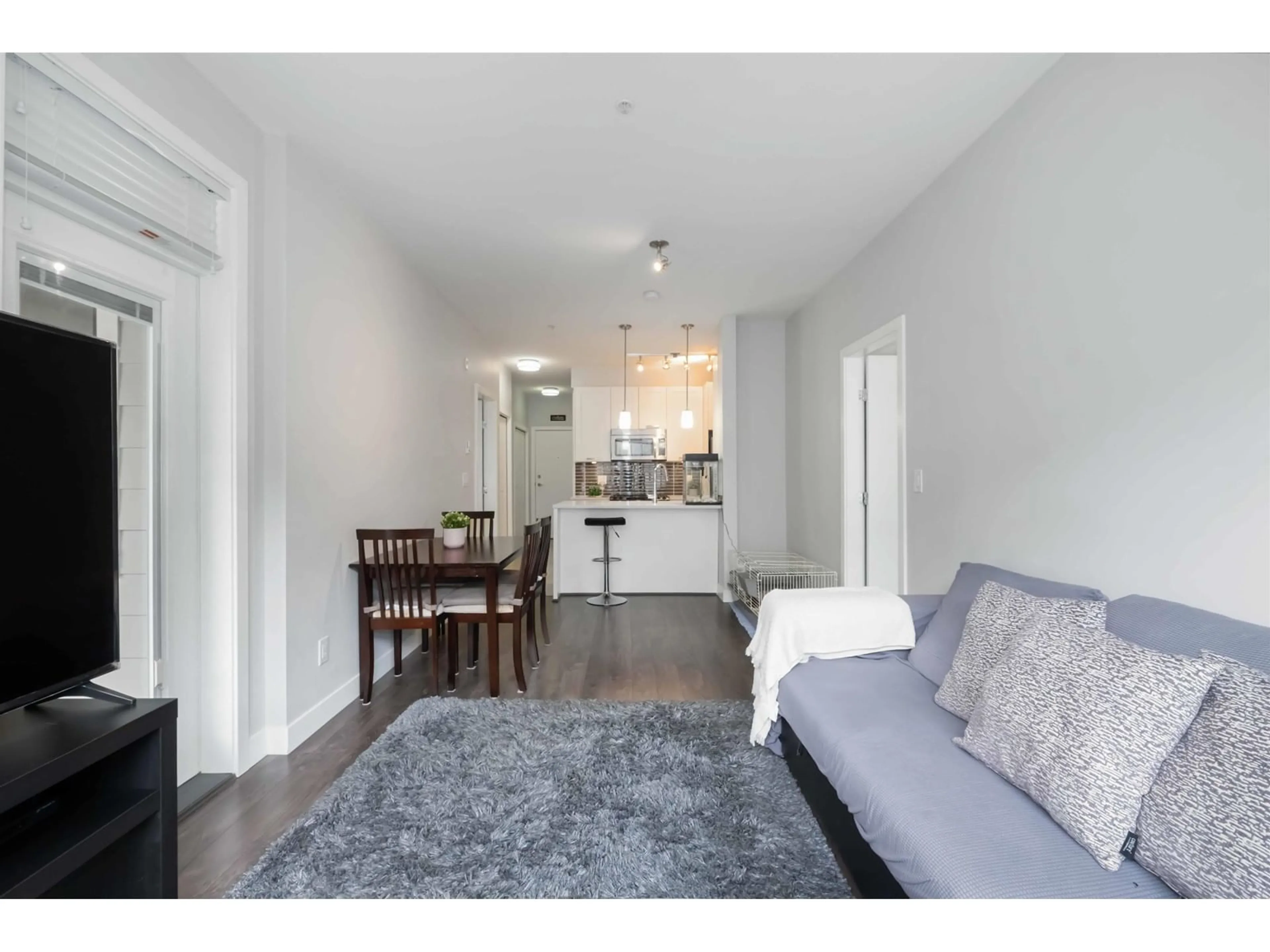 Living room with furniture, wood/laminate floor for 208 - 10455 154, Surrey British Columbia V3R0C5