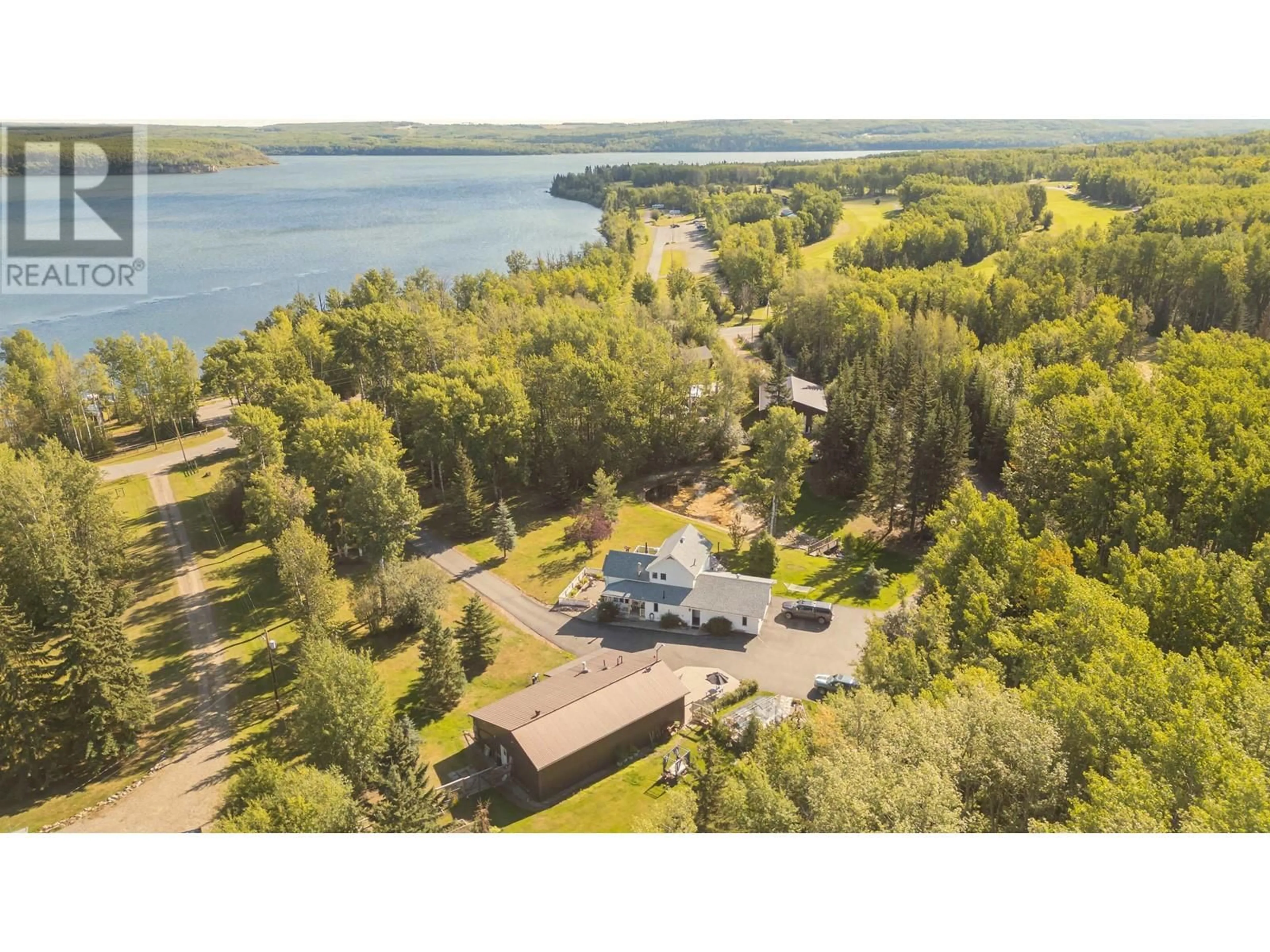 A pic from outside/outdoor area/front of a property/back of a property/a pic from drone, water/lake/river/ocean view for 13744 GOLF COURSE ROAD, Charlie Lake British Columbia V1J8K8