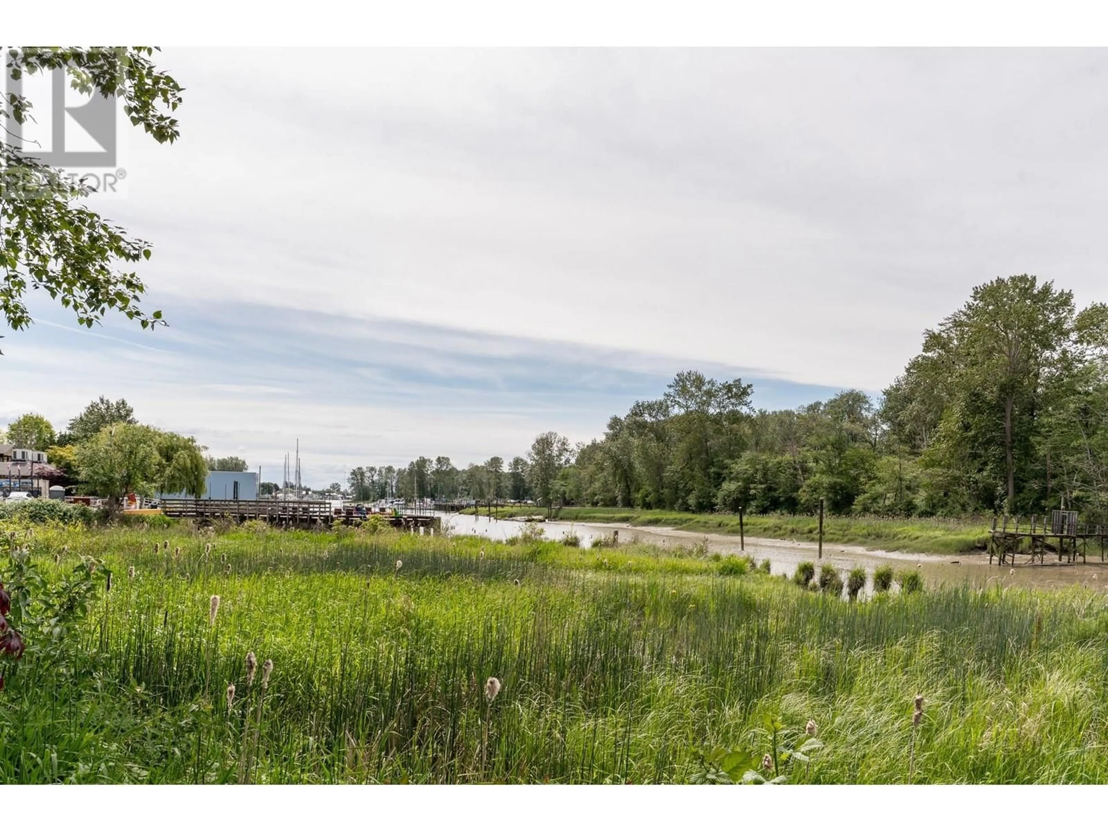 A pic from outside/outdoor area/front of a property/back of a property/a pic from drone, water/lake/river/ocean view for 207 - 4955 RIVER ROAD, Delta British Columbia V4K4V9