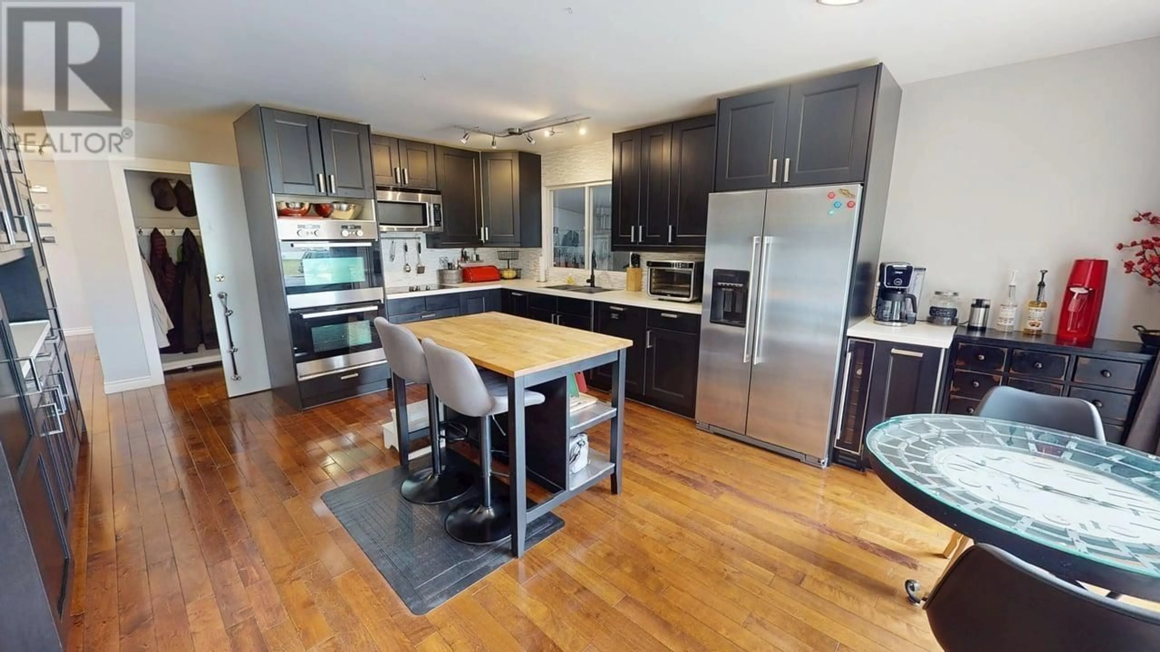 Open concept kitchen, wood/laminate floor for 9516 113 AVENUE, Fort St. John British Columbia V1J2W9