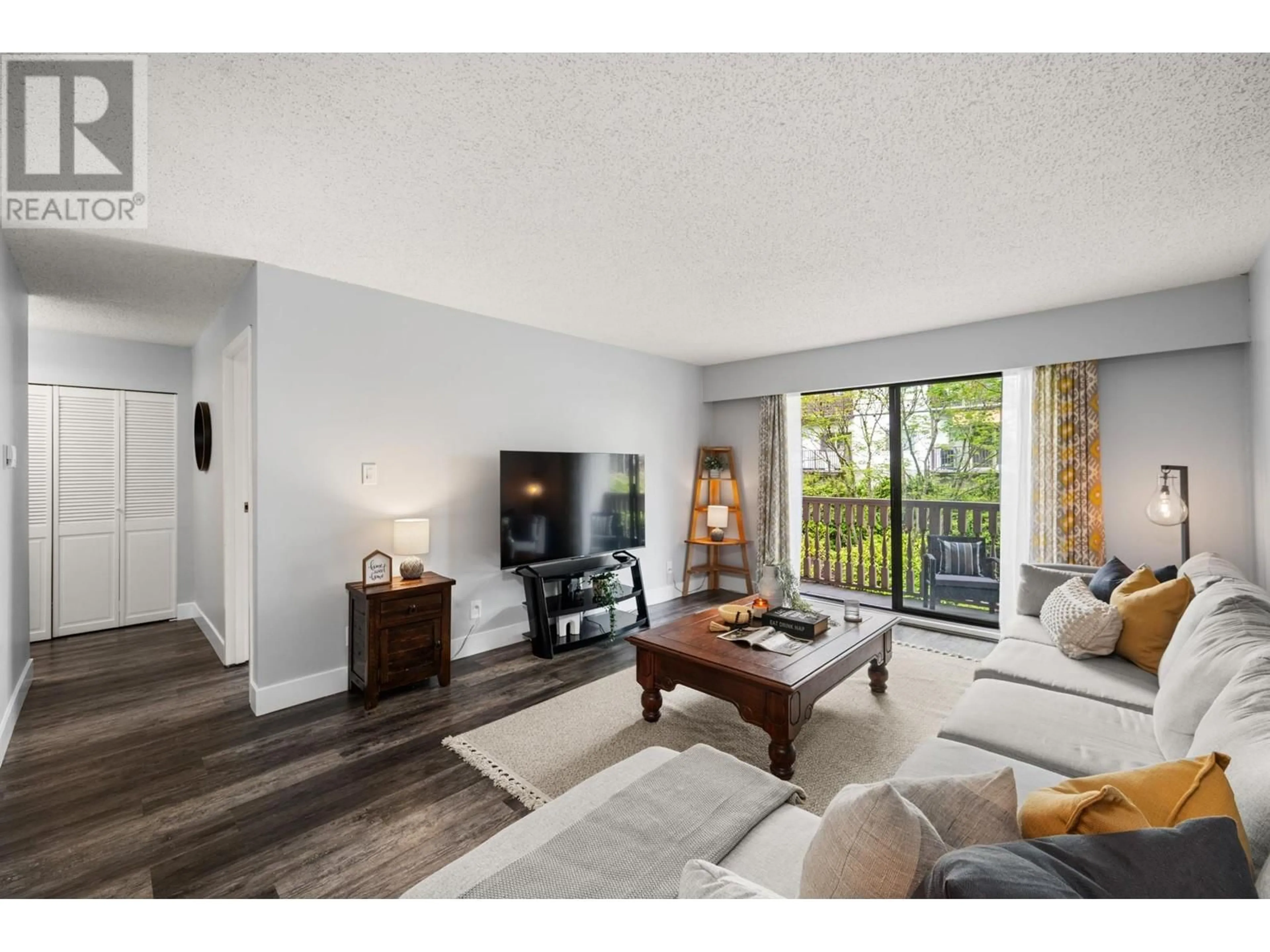 Living room with furniture, wood/laminate floor for 211 - 236 2ND STREET, North Vancouver British Columbia V7M1C6