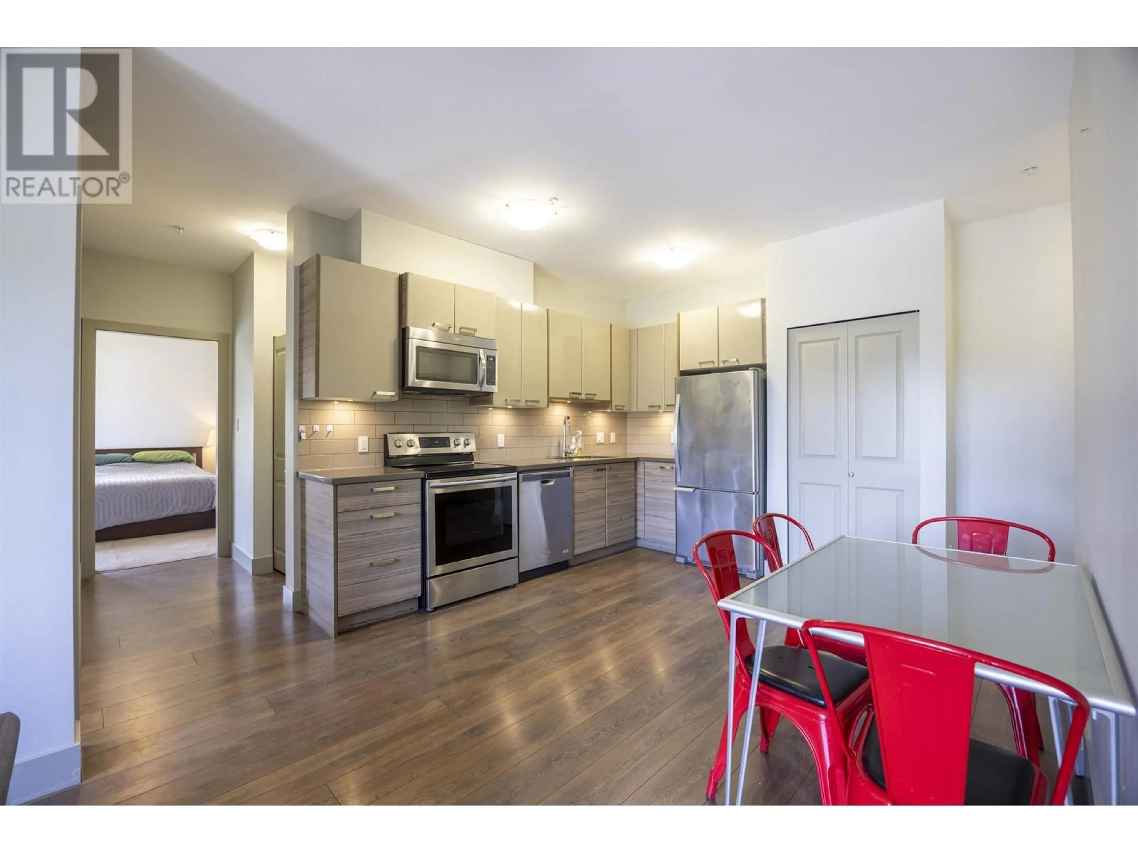 Open concept kitchen, wood/laminate floor for 210 - 6875 DUNBLANE AVENUE, Burnaby British Columbia V5J0G6