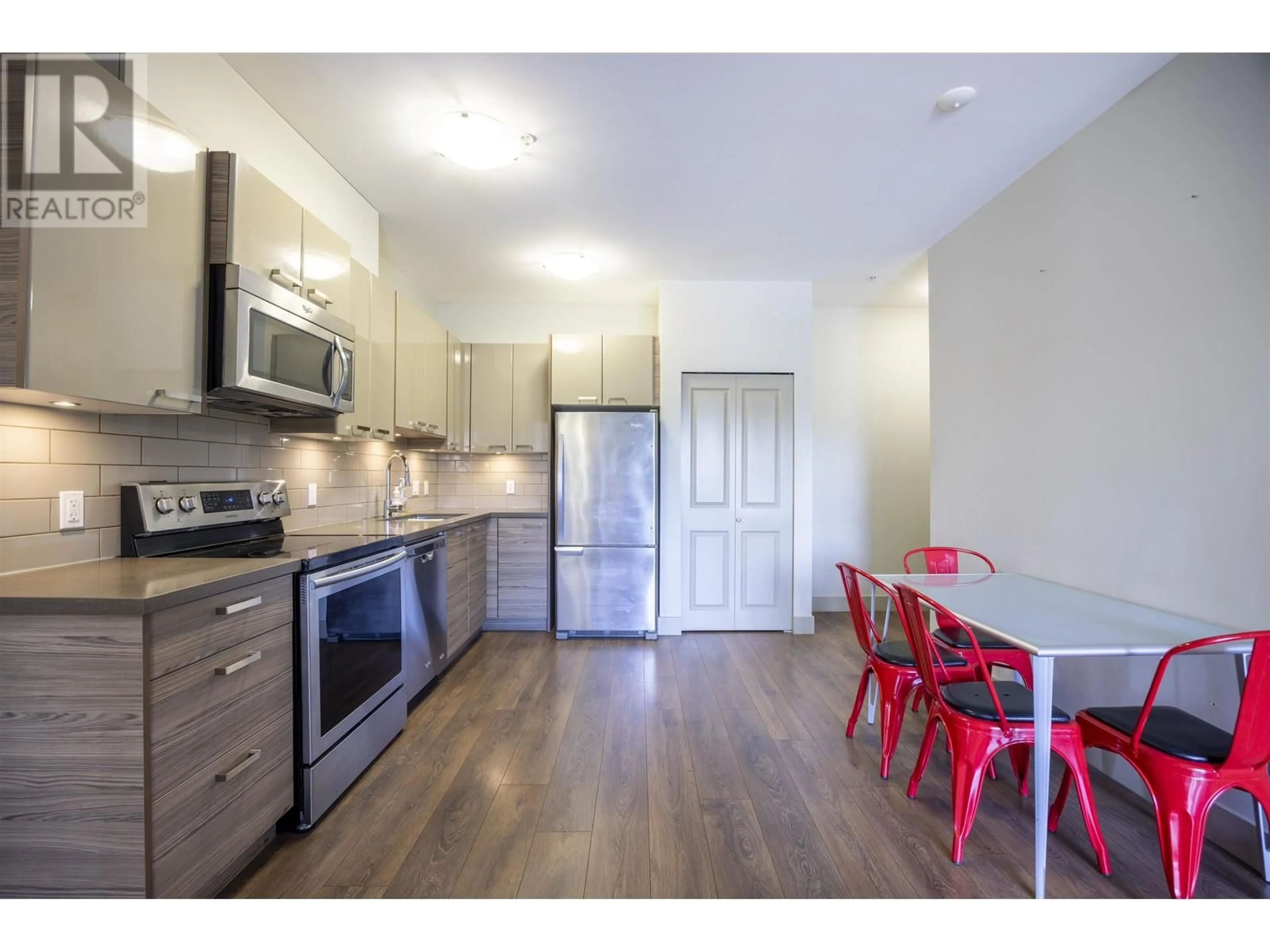Open concept kitchen, wood/laminate floor for 210 - 6875 DUNBLANE AVENUE, Burnaby British Columbia V5J0G6