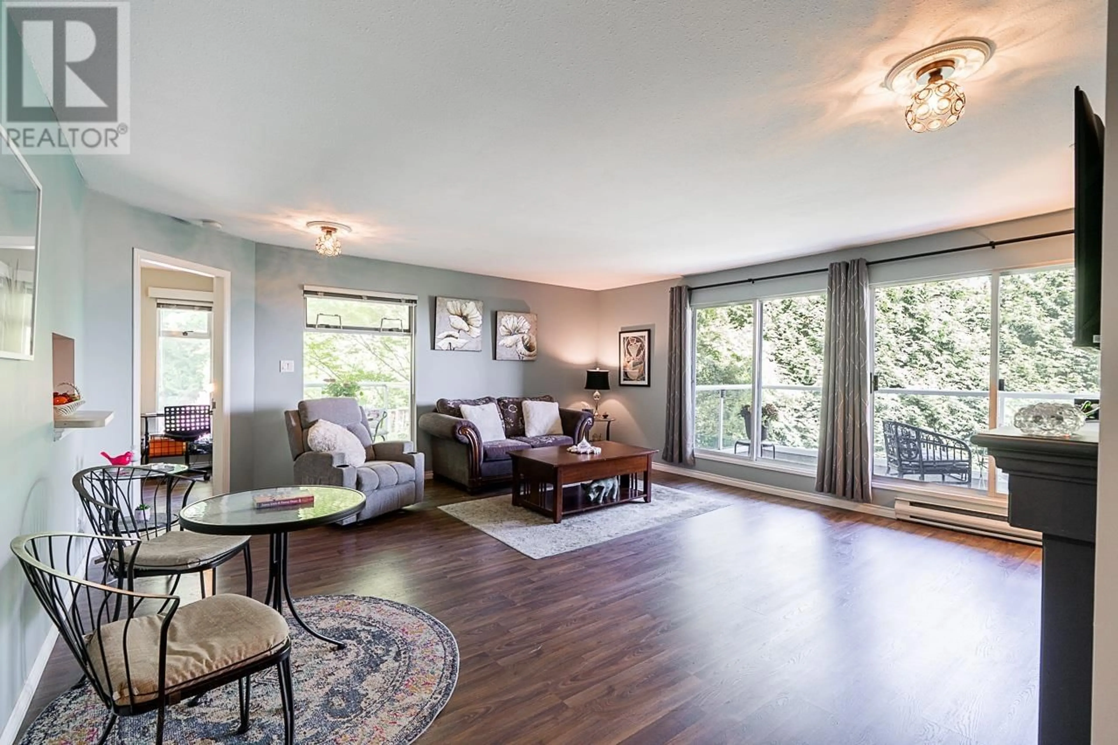 Living room with furniture, wood/laminate floor for 308 - 2733 ATLIN PLACE, Coquitlam British Columbia V3C5B1