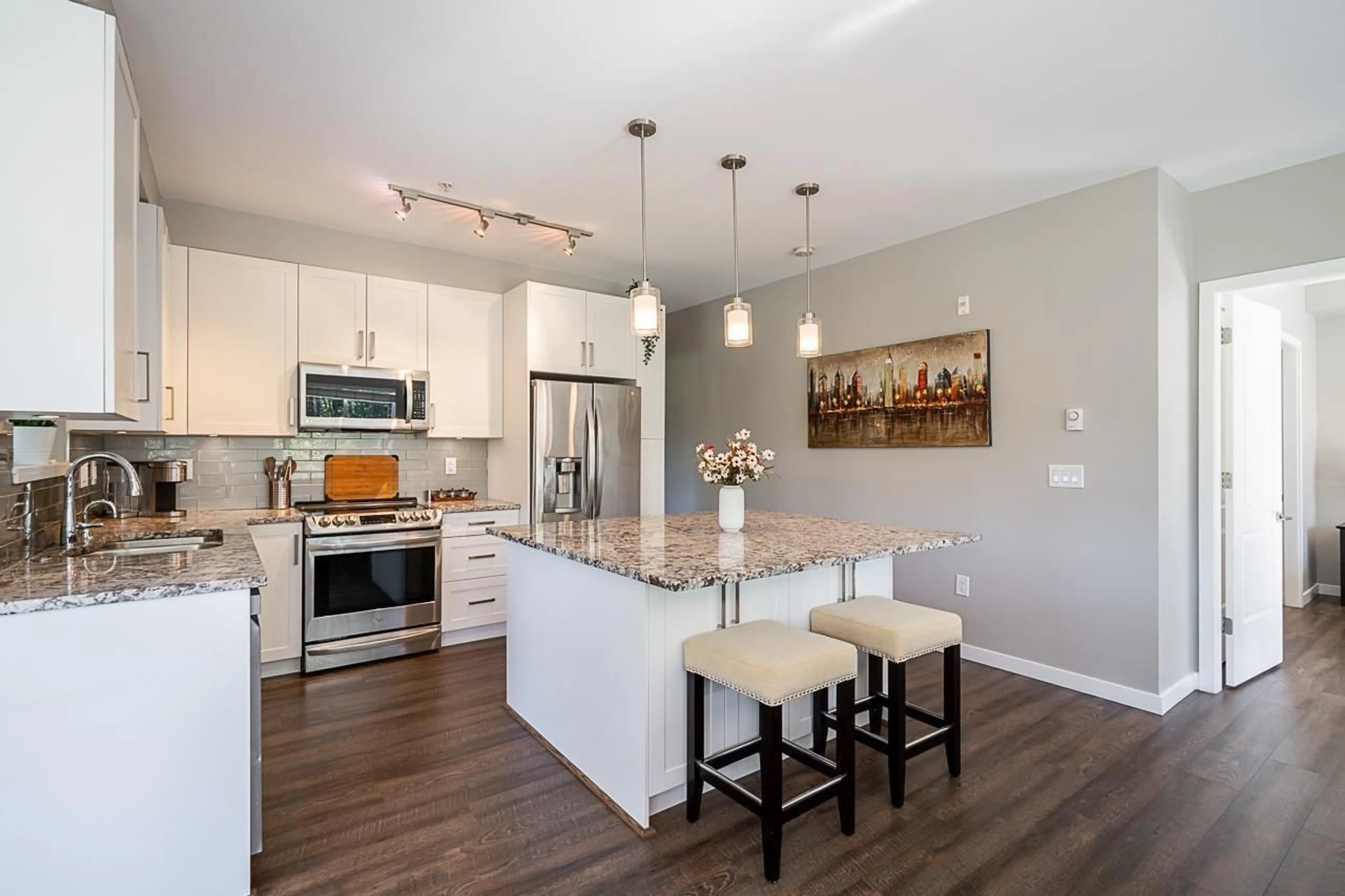 Open concept kitchen, wood/laminate floor for 307 - 6490 194, Surrey British Columbia V4N6J9