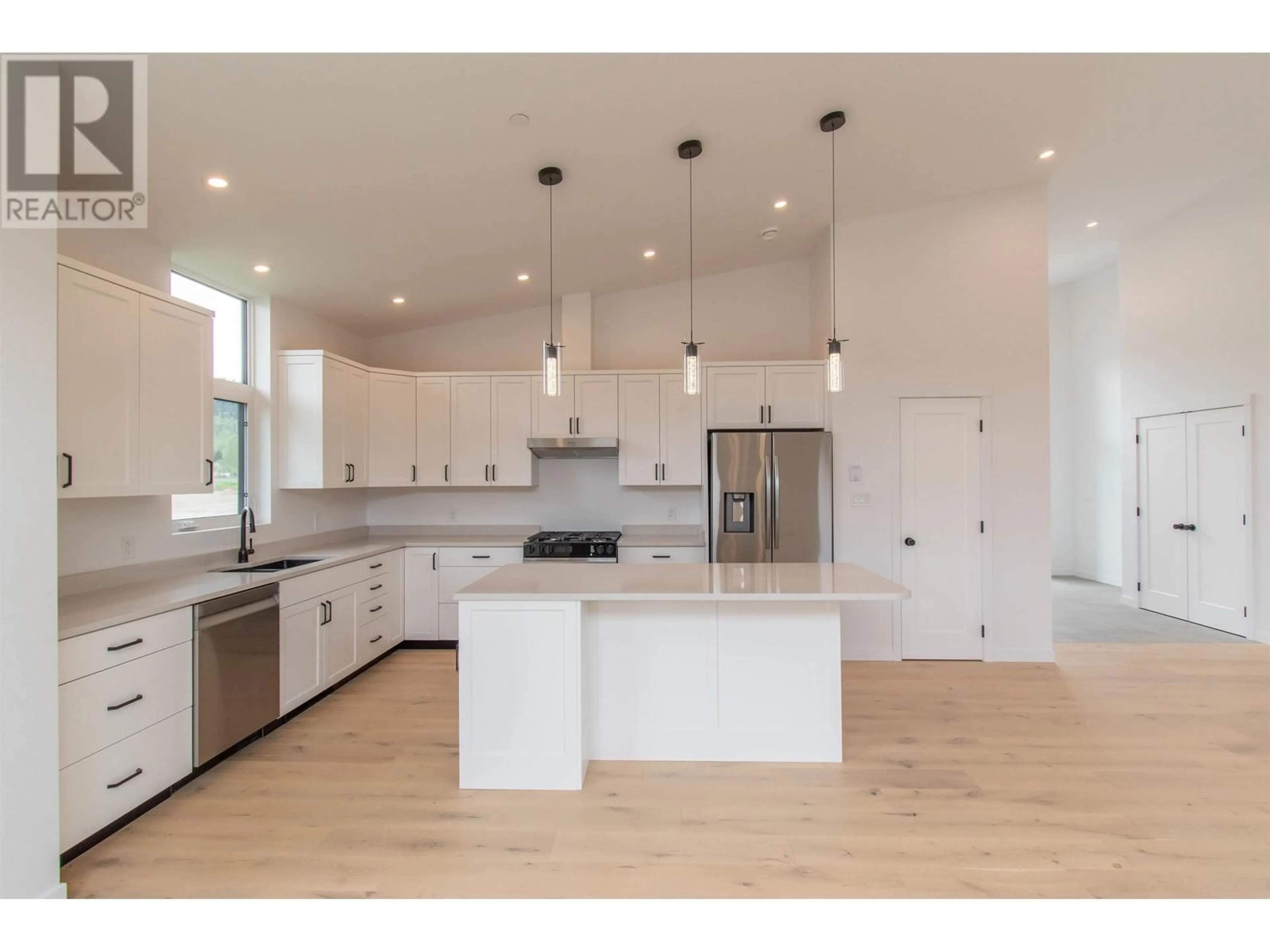 Open concept kitchen, wood/laminate floor for 1118 PARKSIDE AVENUE, Smithers British Columbia V0J2N0