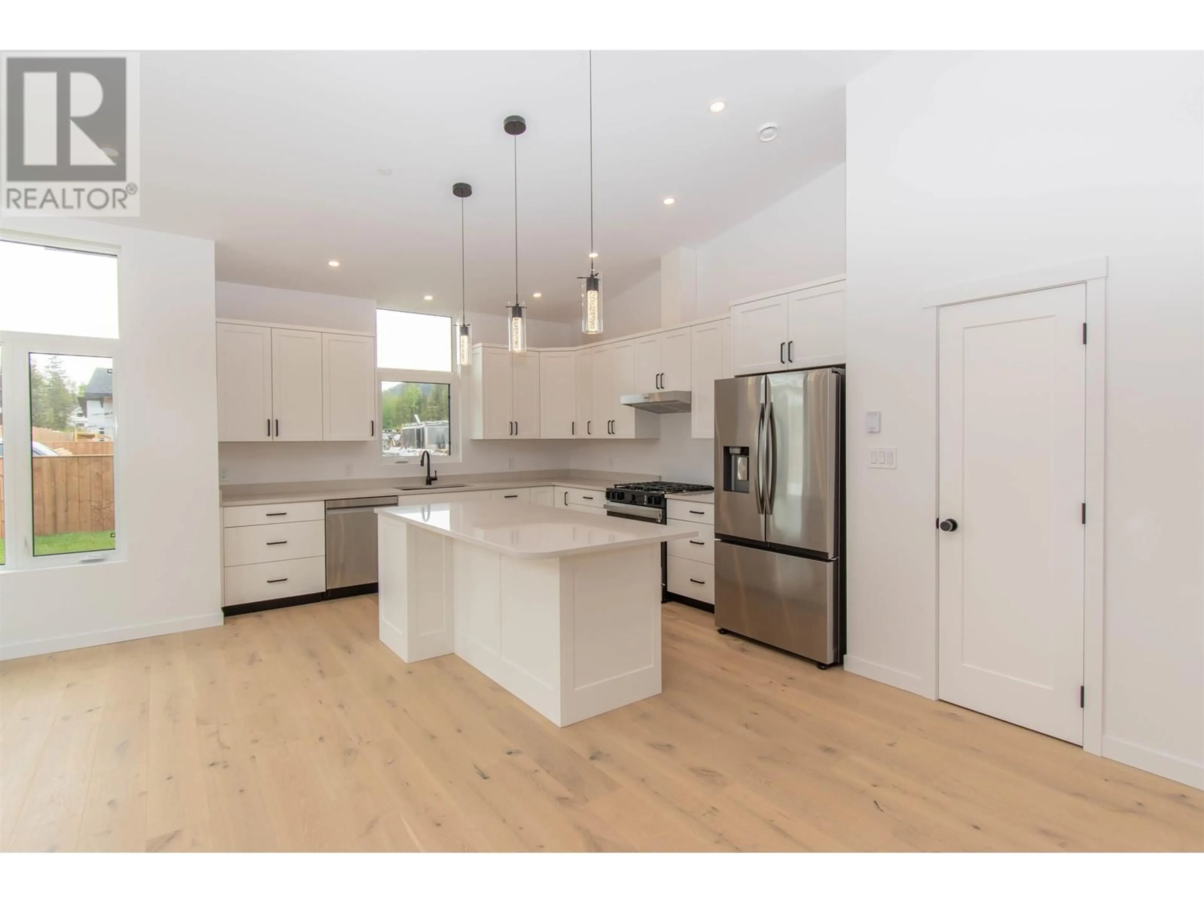 Open concept kitchen, wood/laminate floor for 1118 PARKSIDE AVENUE, Smithers British Columbia V0J2N0