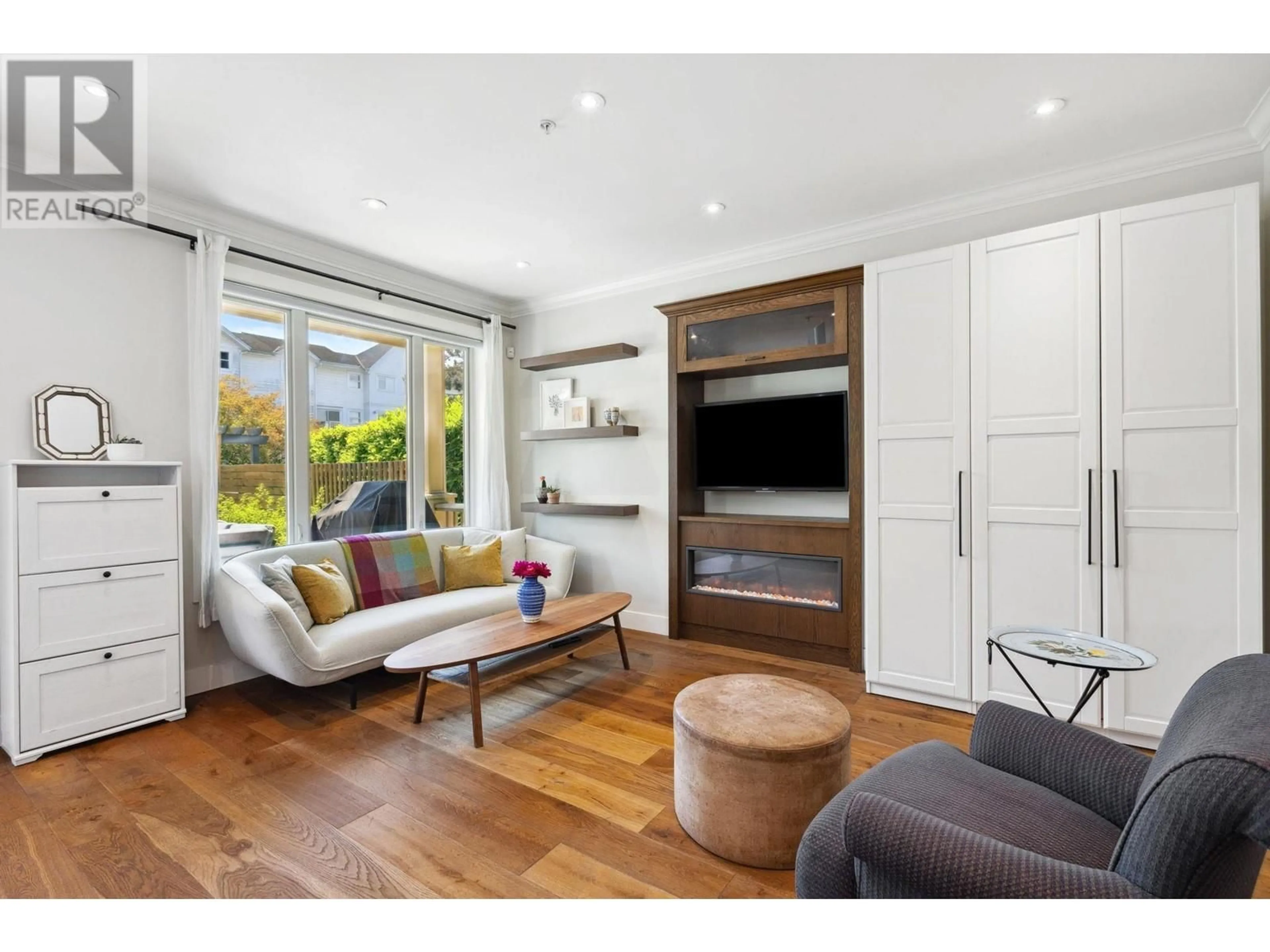 Living room with furniture, wood/laminate floor for 1669 ADANAC STREET, Vancouver British Columbia V5L2C7