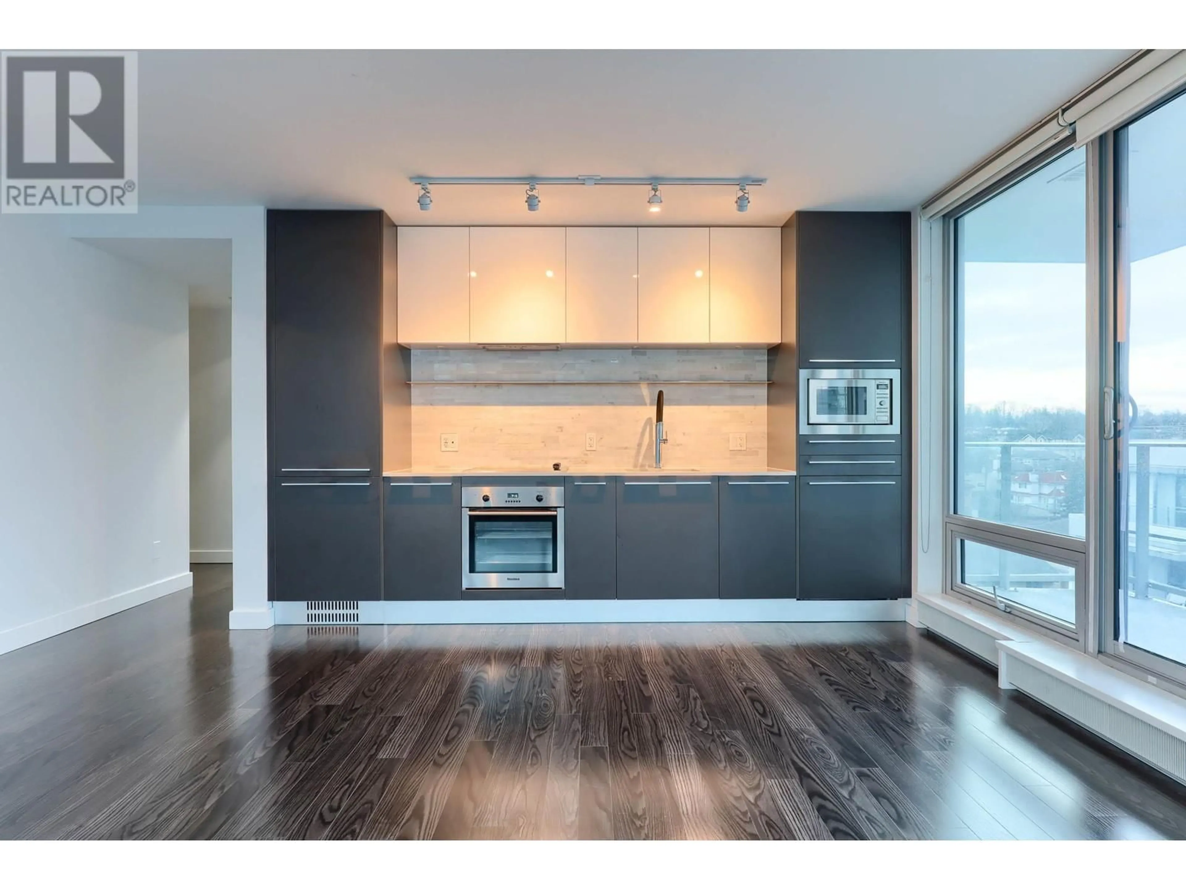 Open concept kitchen, wood/laminate floor for 606 - 8031 NUNAVUT LANE, Vancouver British Columbia V5X0C9