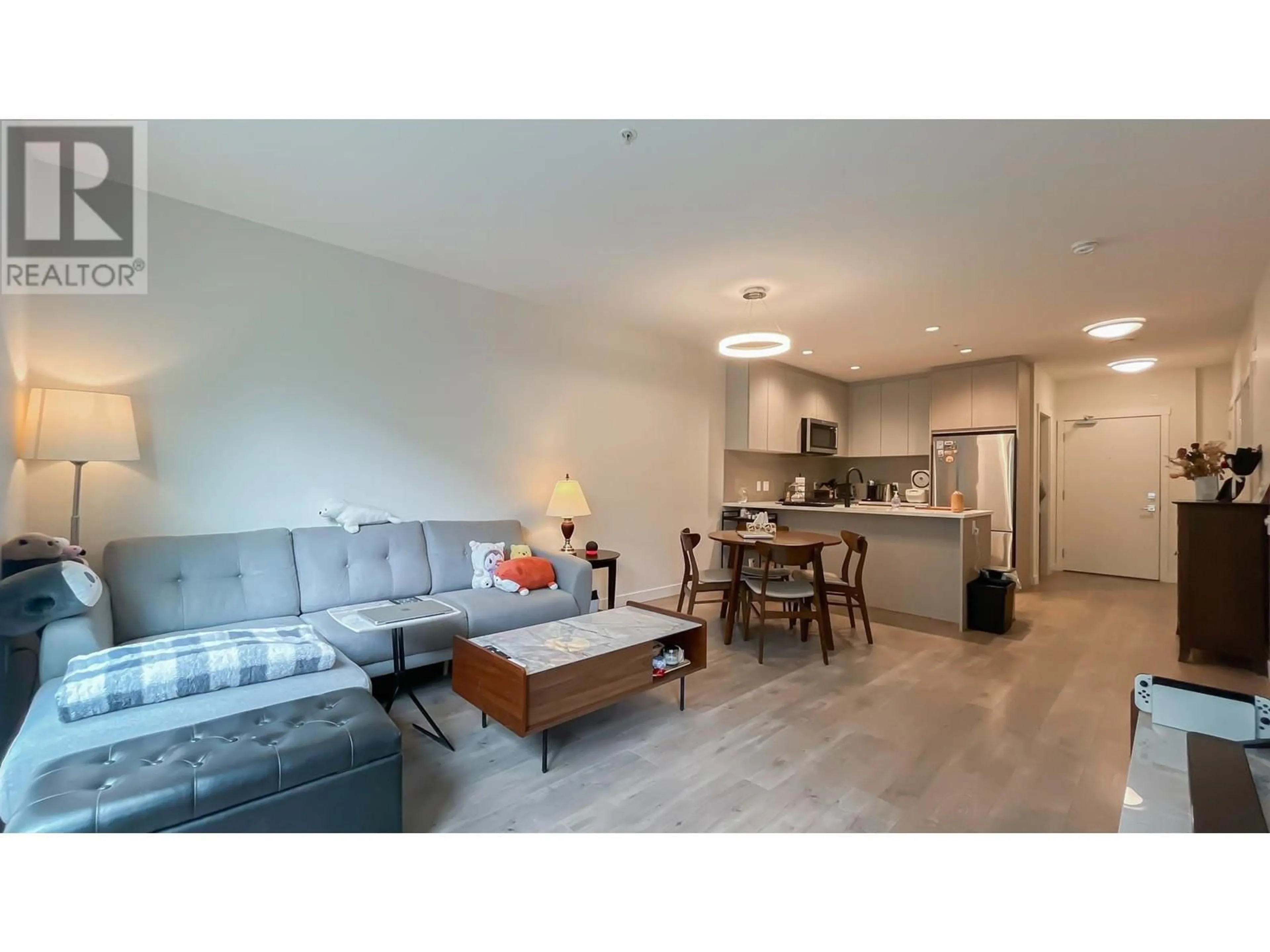 Living room with furniture, wood/laminate floor for 104 - 707 COMO LAKE AVENUE, Coquitlam British Columbia V3J0J5