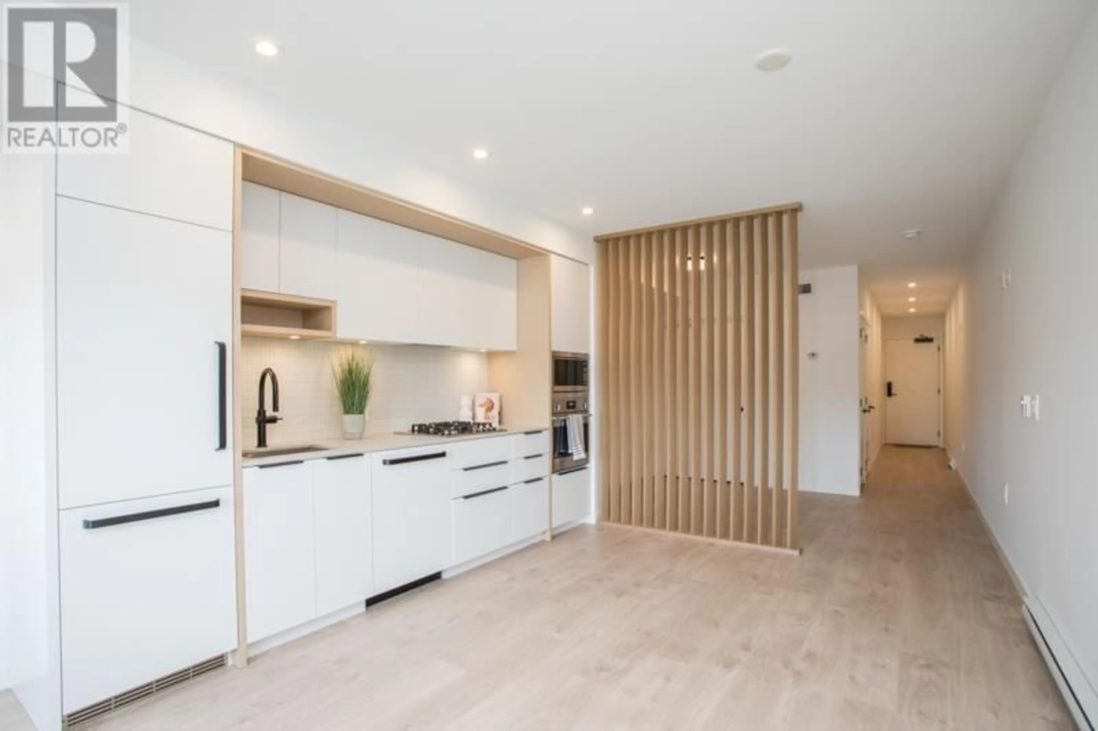 Contemporary kitchen, wood/laminate floor for 210 - 2520 GUELPH STREET, Vancouver British Columbia V5T0K7