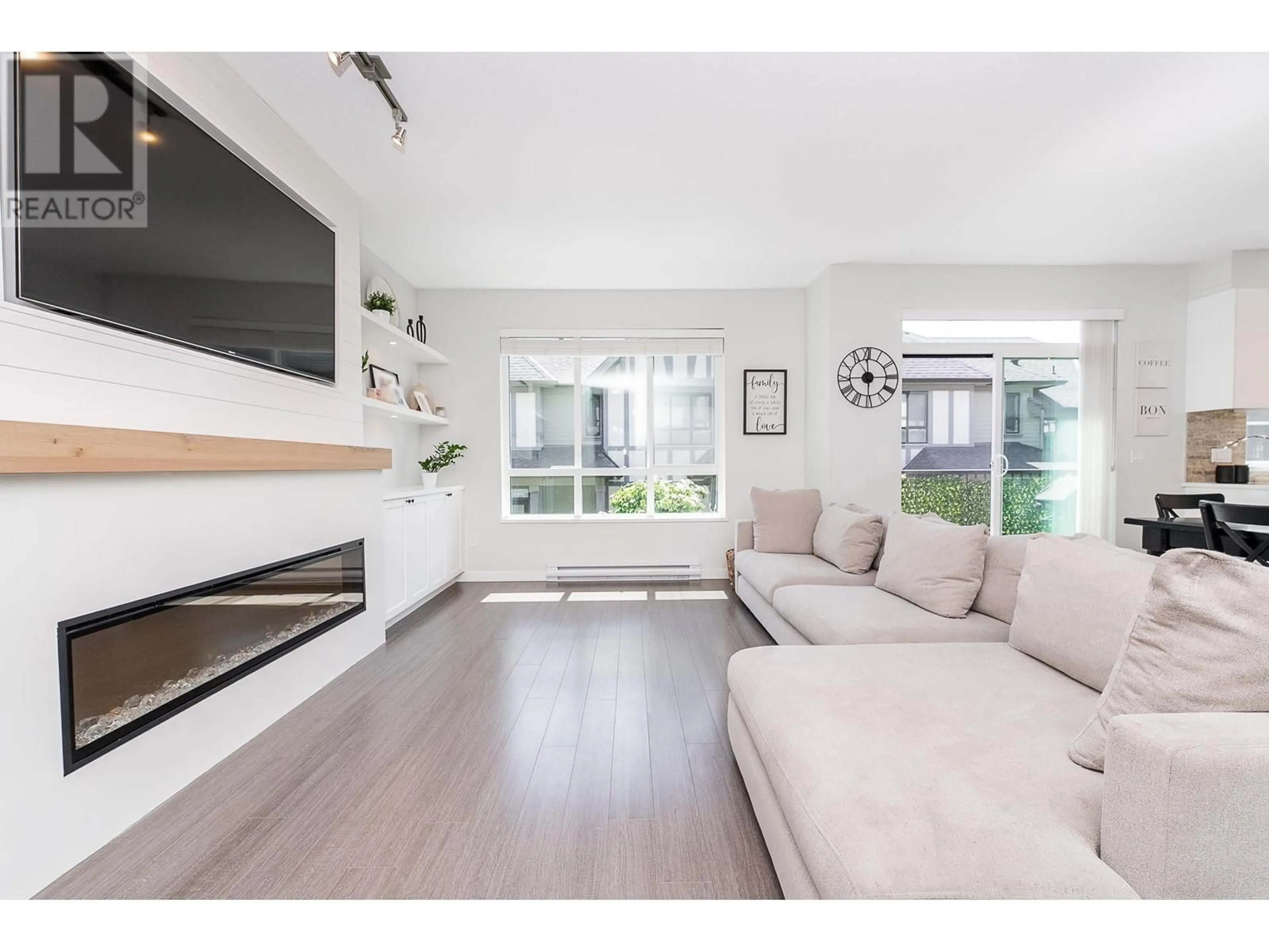 Living room with furniture, wood/laminate floor for 135 - 3500 BURKE VILLAGE PROMENADE, Coquitlam British Columbia V3E0N2