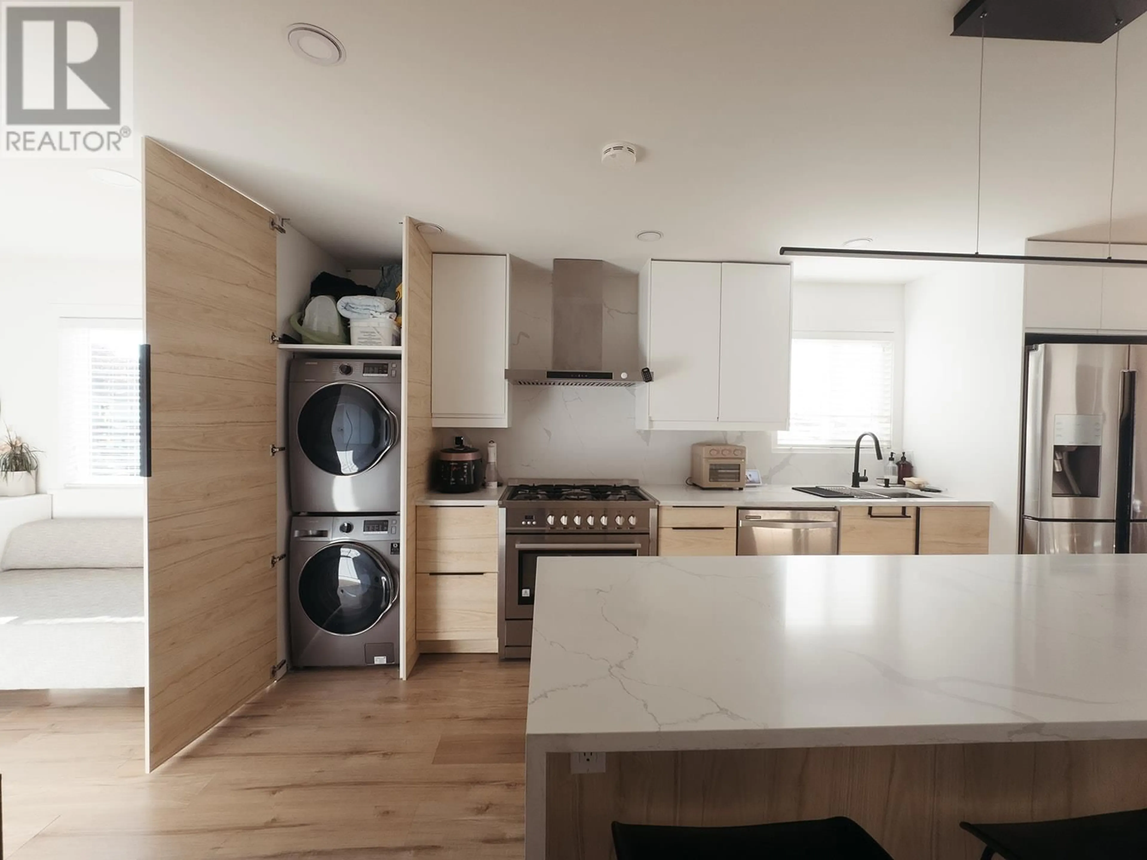 Kitchen with laundary machines, wood/laminate floor for 679 GAMMA AVENUE, Burnaby British Columbia V5C6A3