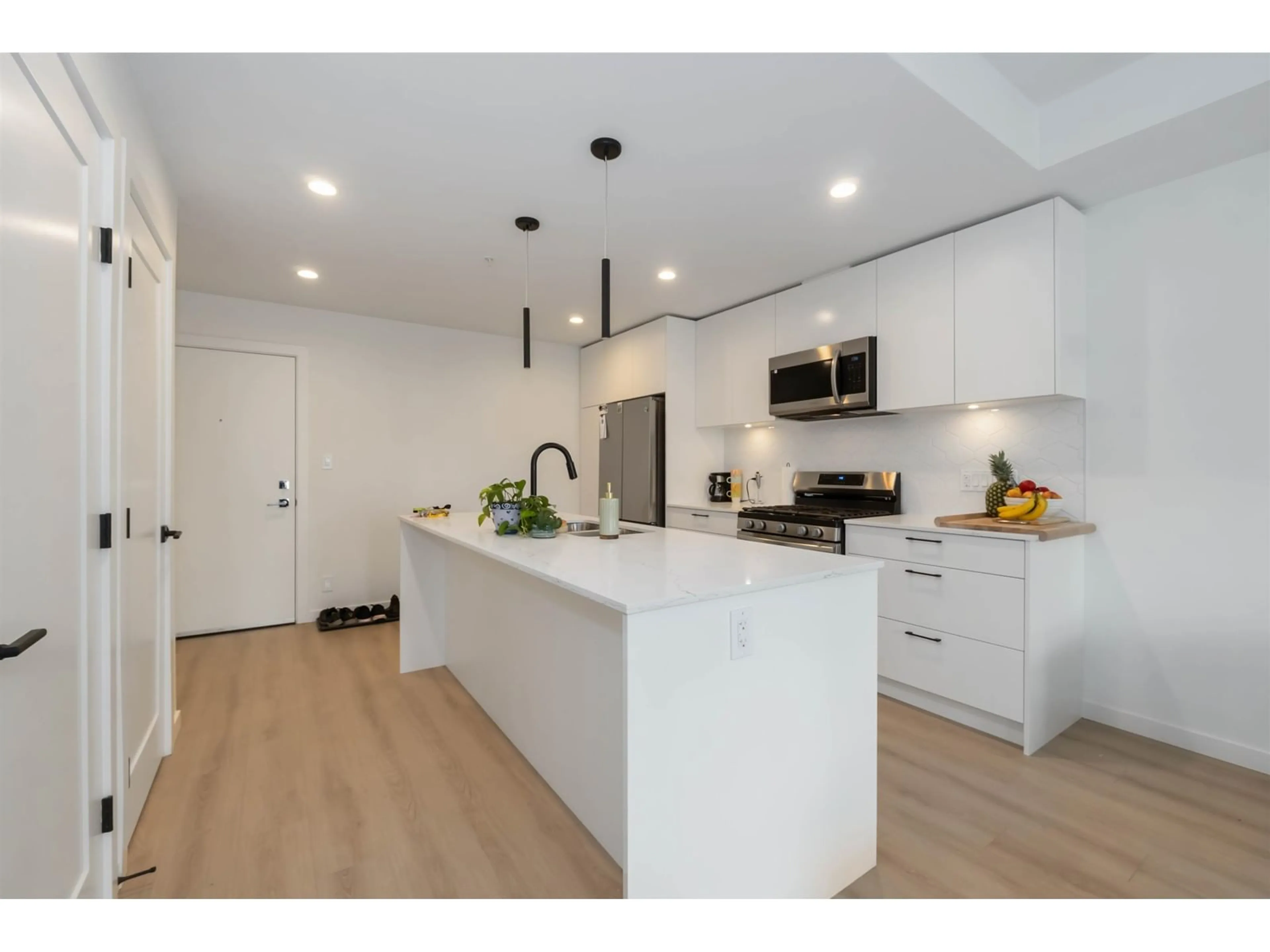 Open concept kitchen, wood/laminate floor for A207 - 20078 85, Langley British Columbia V2Y3Z2