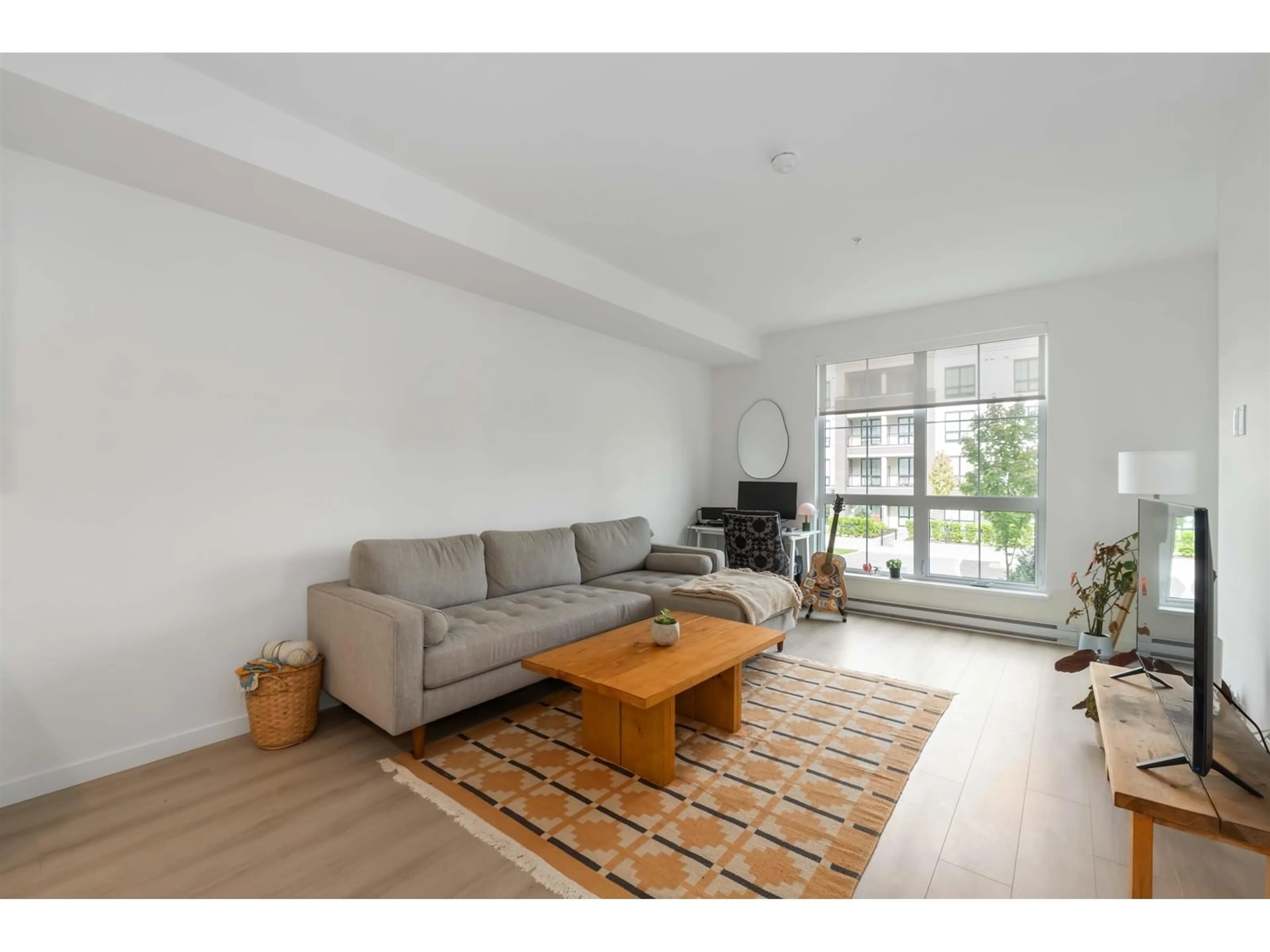 Living room with furniture, wood/laminate floor for A207 - 20078 85, Langley British Columbia V2Y3Z2