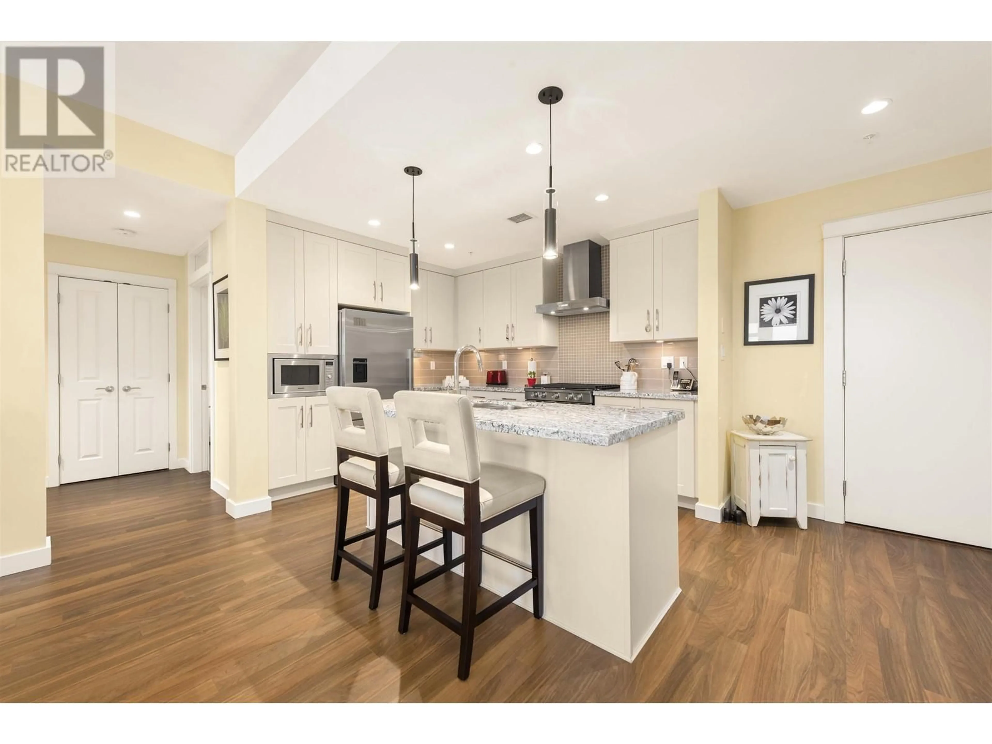 Open concept kitchen, wood/laminate floor for 406 - 5055 SPRINGS BOULEVARD, Delta British Columbia V4M0A5