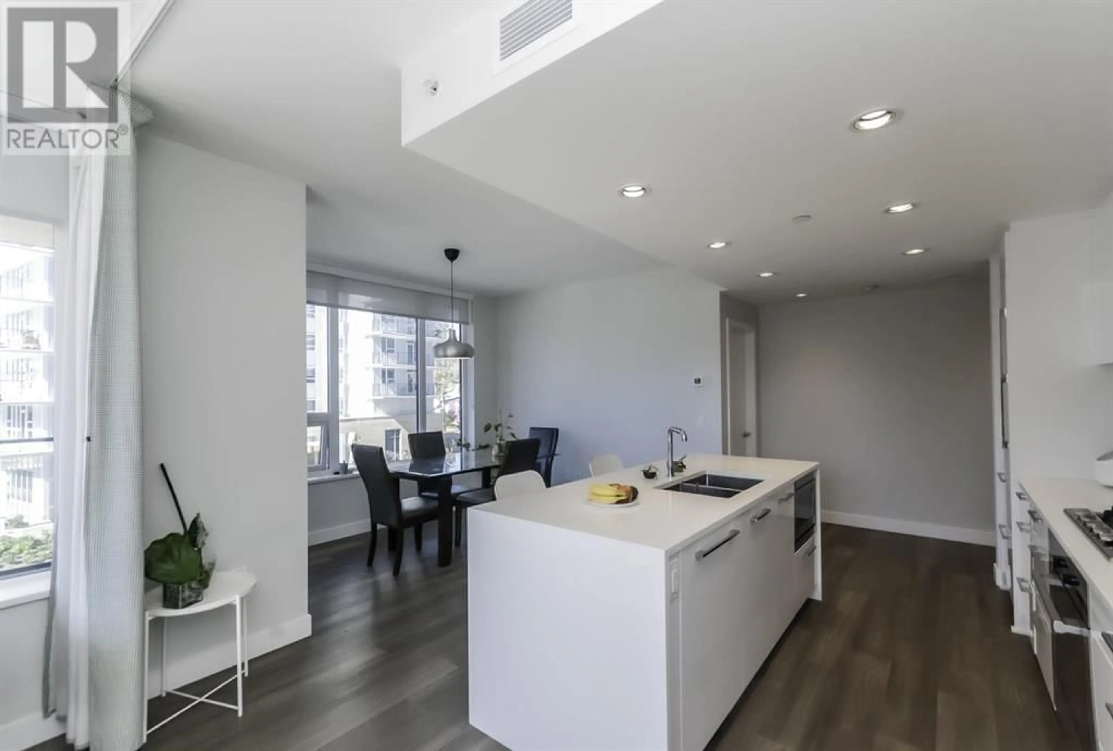Open concept kitchen, wood/laminate floor for 306 - 5410 SHORTCUT ROAD, Vancouver British Columbia V6T0C8