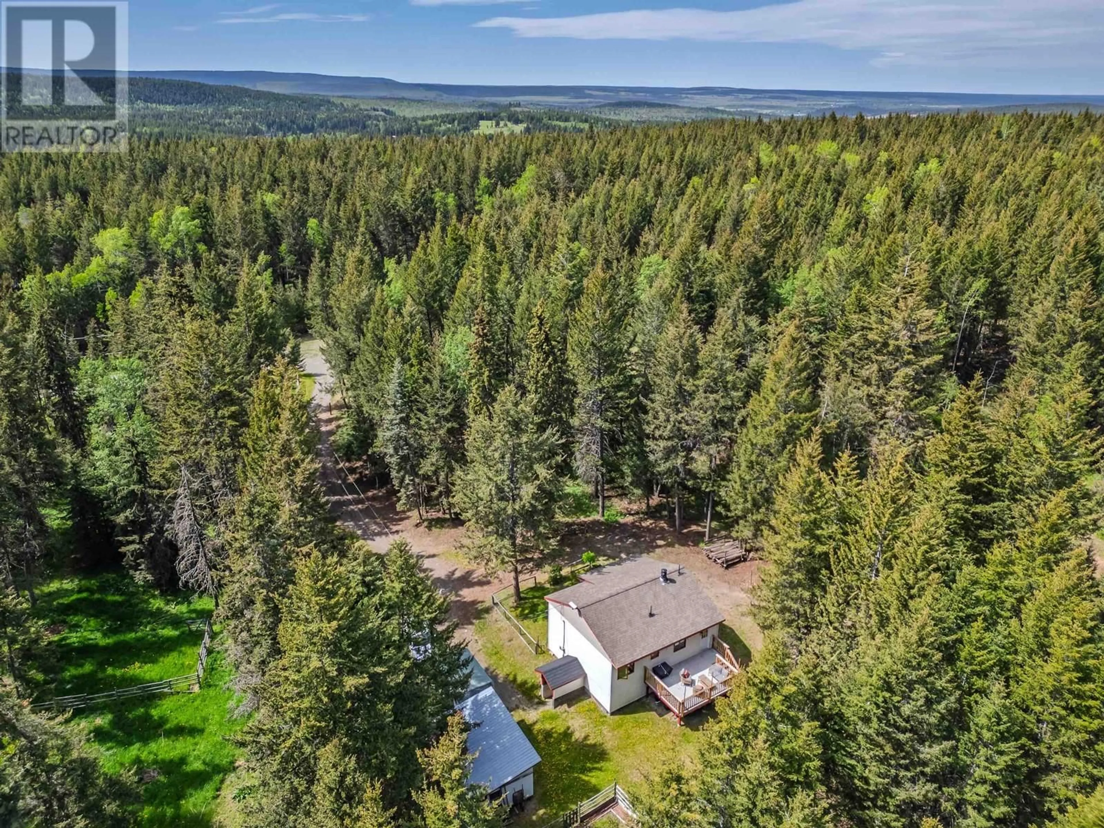 A pic from outside/outdoor area/front of a property/back of a property/a pic from drone, forest/trees view for 4919 LATHAM ROAD, 100 Mile House British Columbia V0K2E1