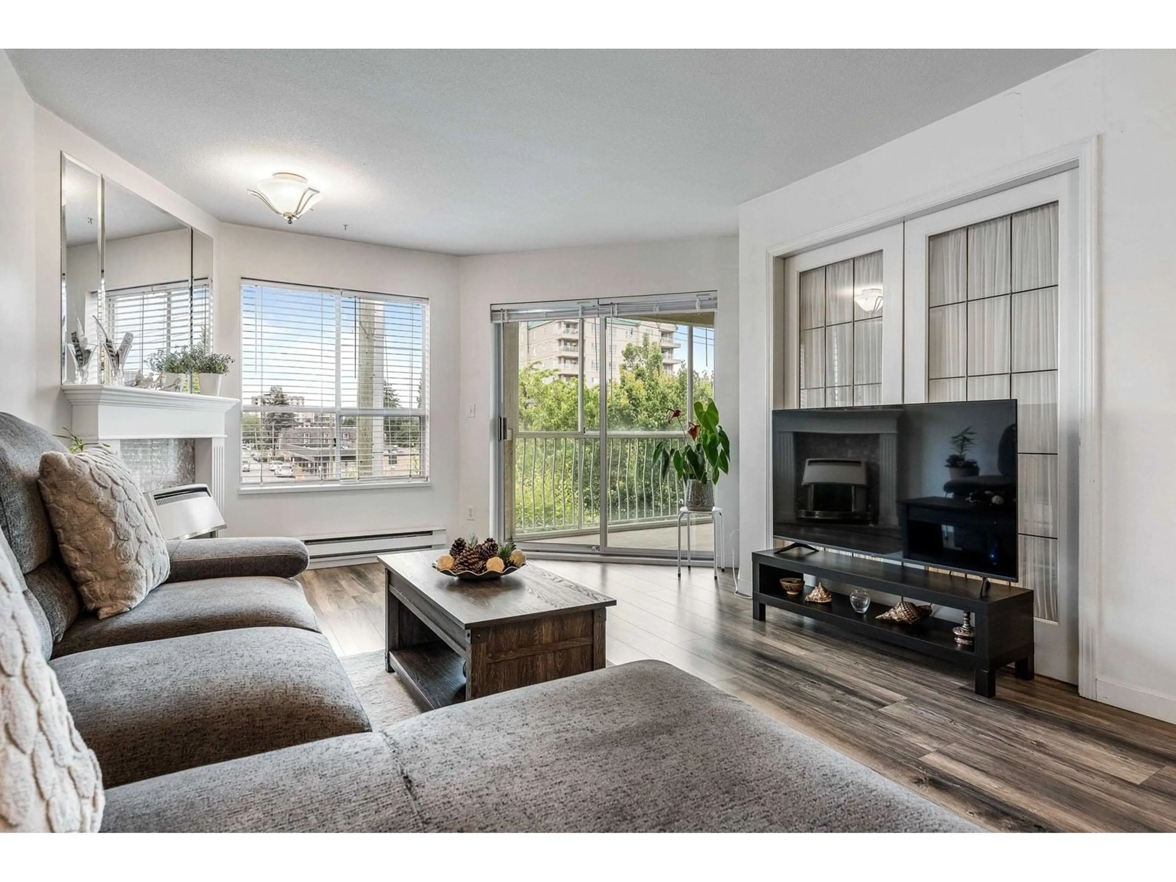 Living room with furniture, wood/laminate floor for 204 - 9400 COOK STREET, Chilliwack British Columbia V2P4J6