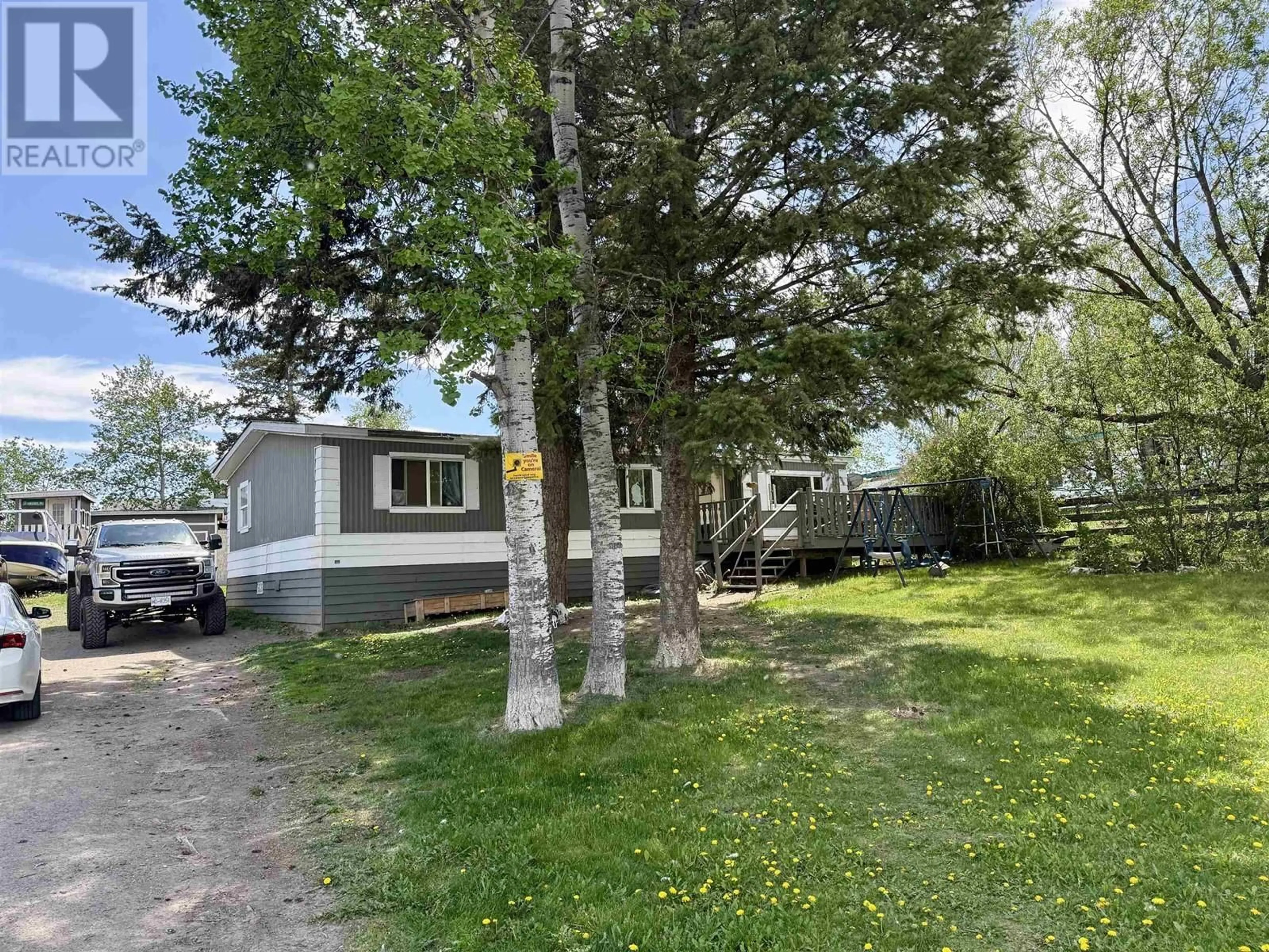 A pic from outside/outdoor area/front of a property/back of a property/a pic from drone, street for 5586 103 MILE LAKE ROAD, 103 Mile House British Columbia V0K2E1