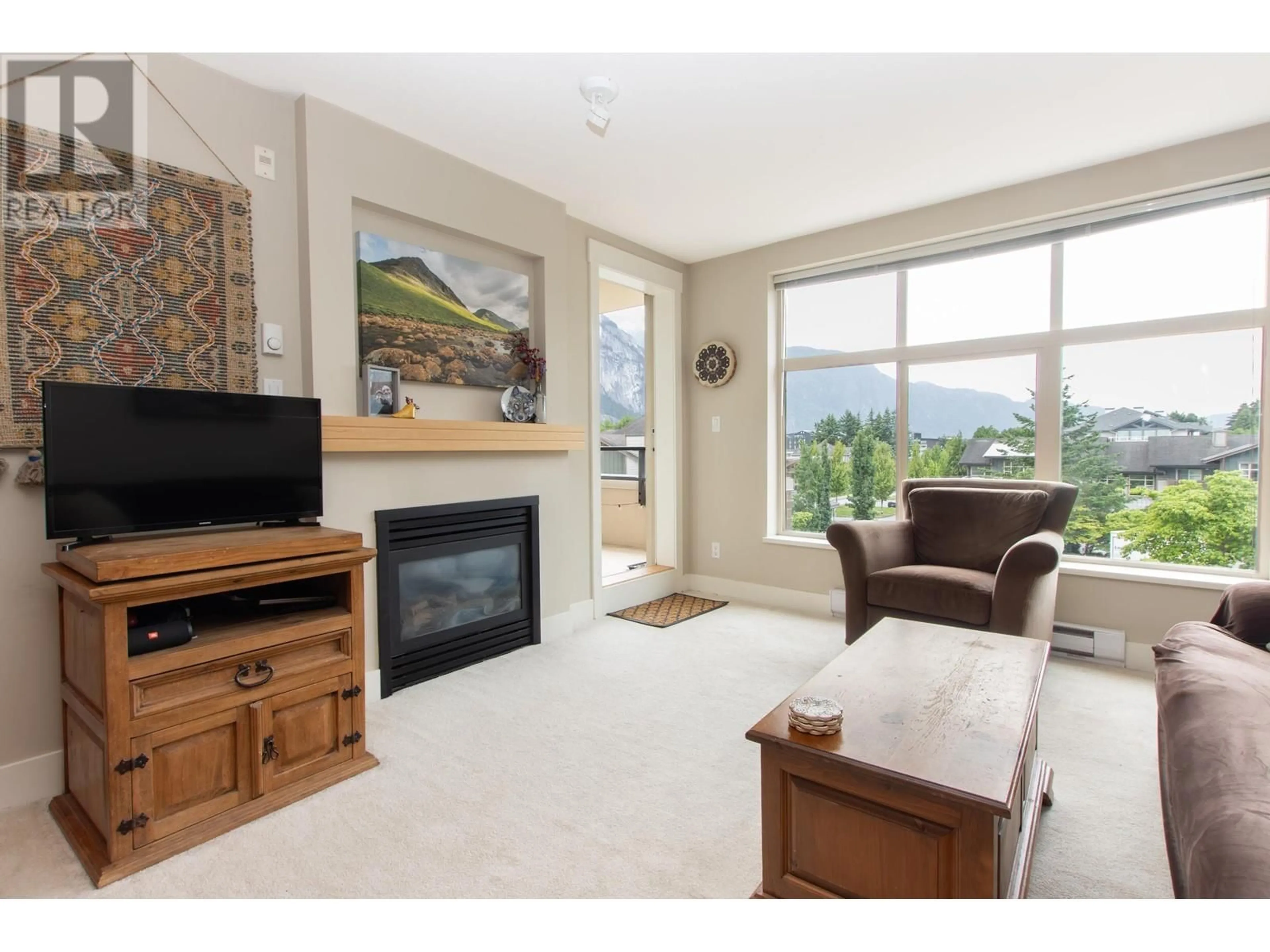 Living room with furniture, unknown for 320 - 1211 VILLAGE GREEN WAY, Squamish British Columbia V8B0R7