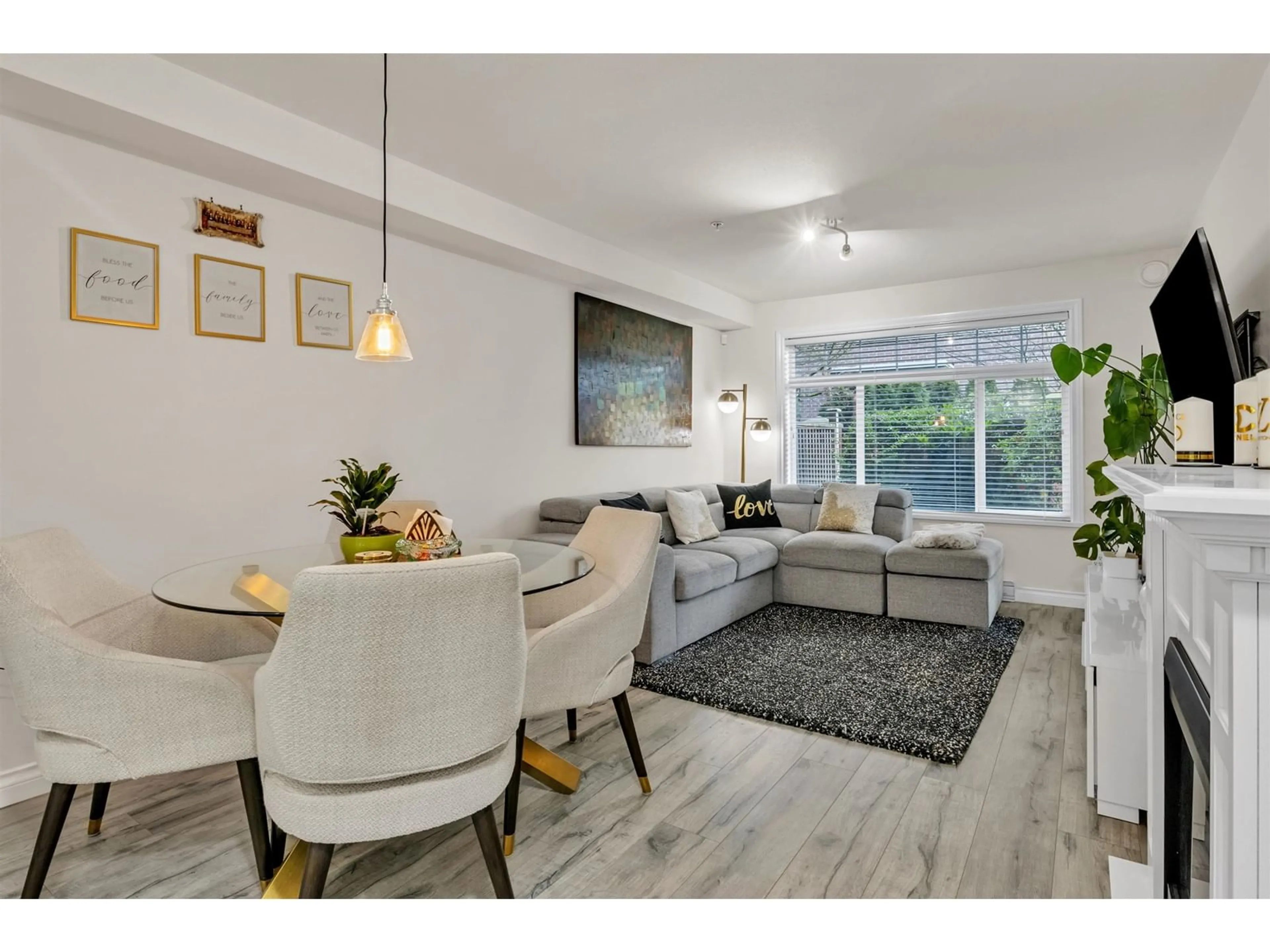 Living room with furniture, wood/laminate floor for 101 - 5650 201A, Langley British Columbia V3A4B6
