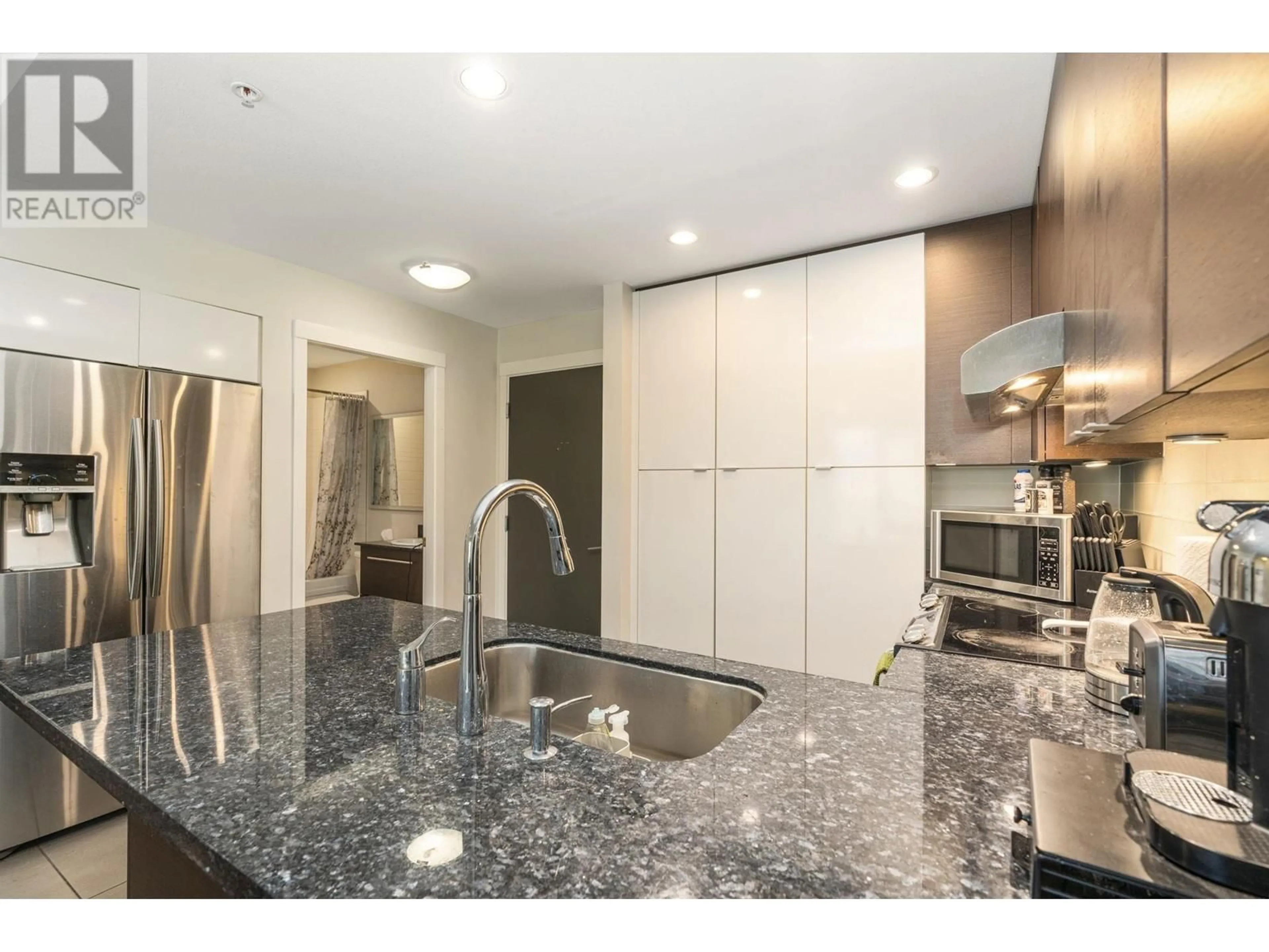 Open concept kitchen, ceramic/tile floor for 212 - 3478 WESBROOK MALL, Vancouver British Columbia V6S0B6